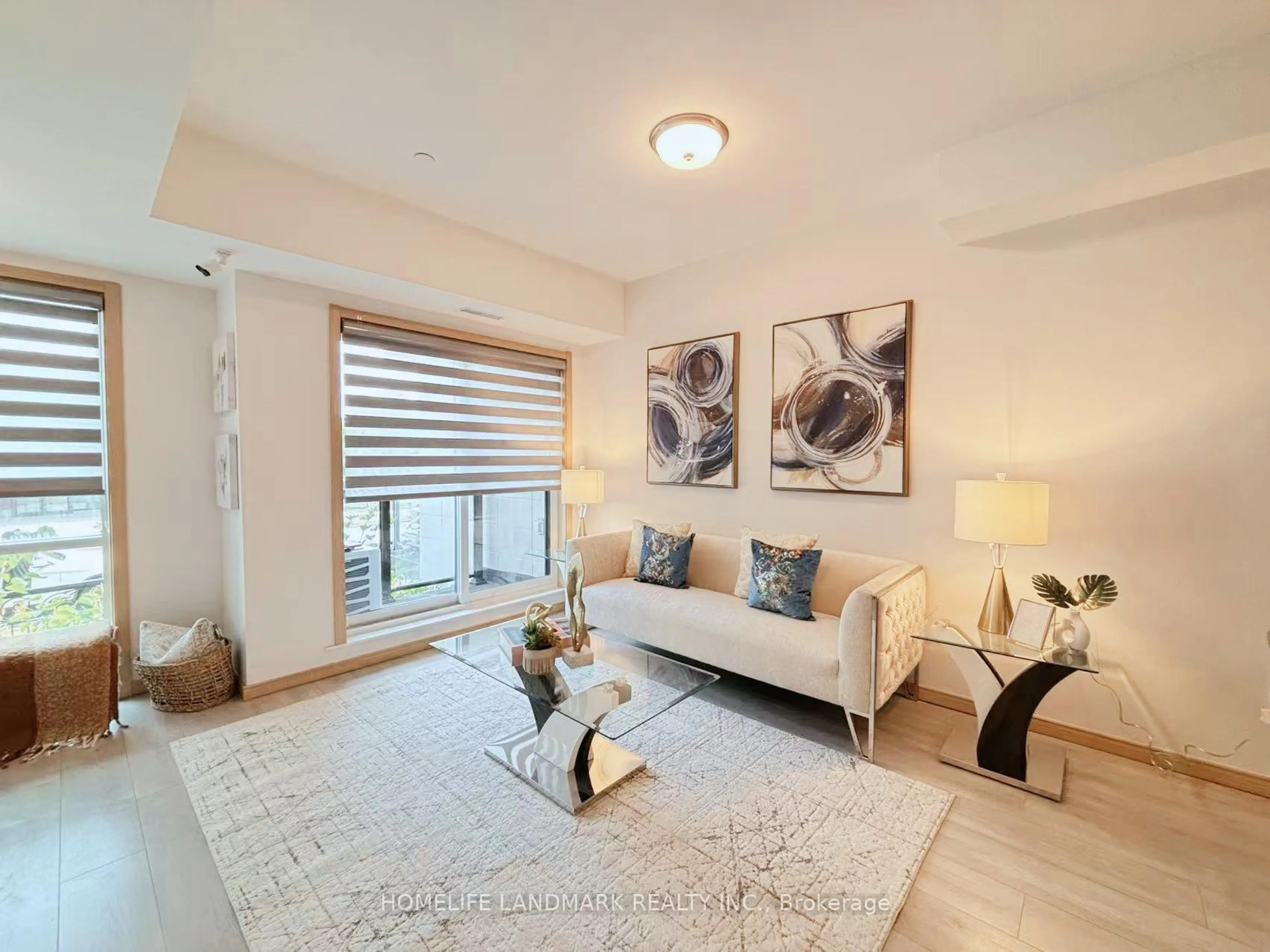 Living room with furniture, wood/laminate floor for 200 Chester Le Blvd #D207, Toronto Ontario M1W 0A9