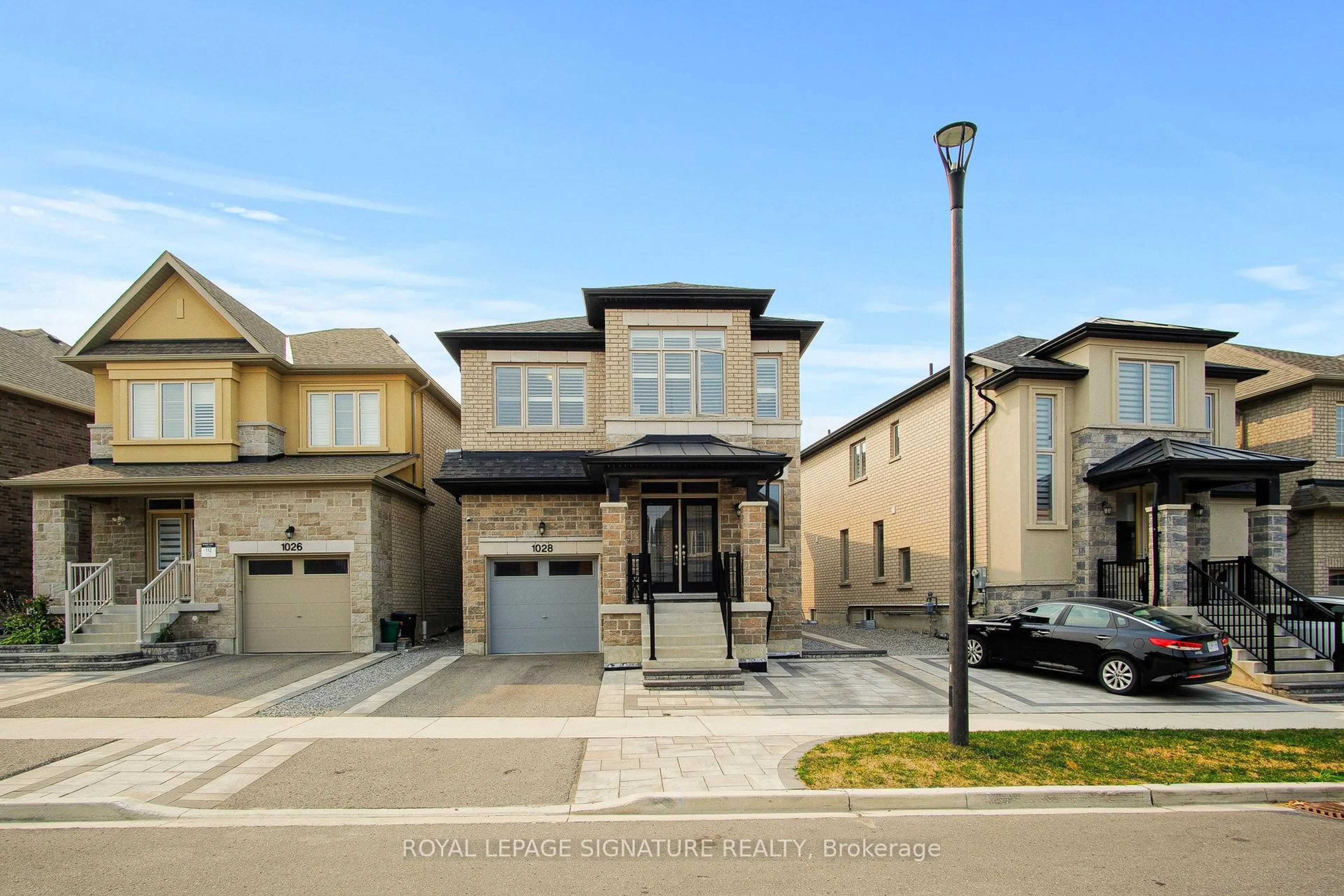 Home with brick exterior material, street for 1028 Pelican Tr, Pickering Ontario L1X 0G7