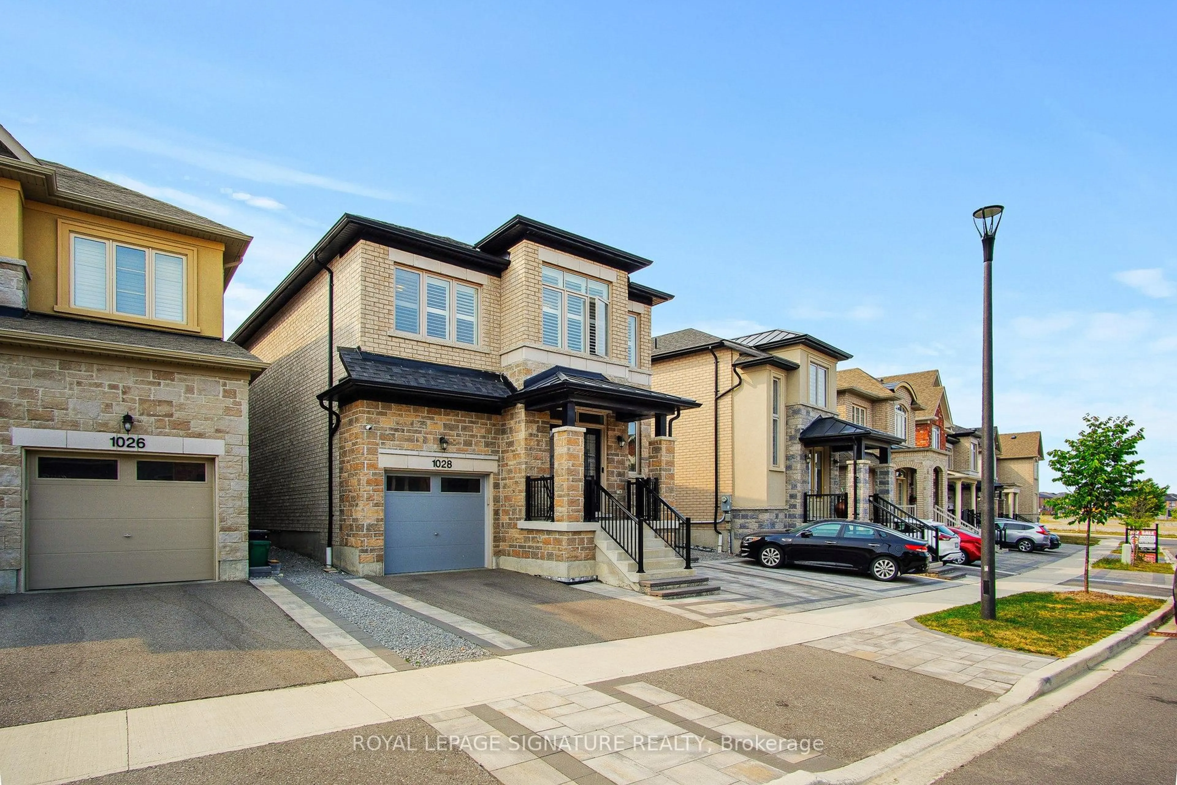 Home with brick exterior material, street for 1028 Pelican Tr, Pickering Ontario L1X 0G7