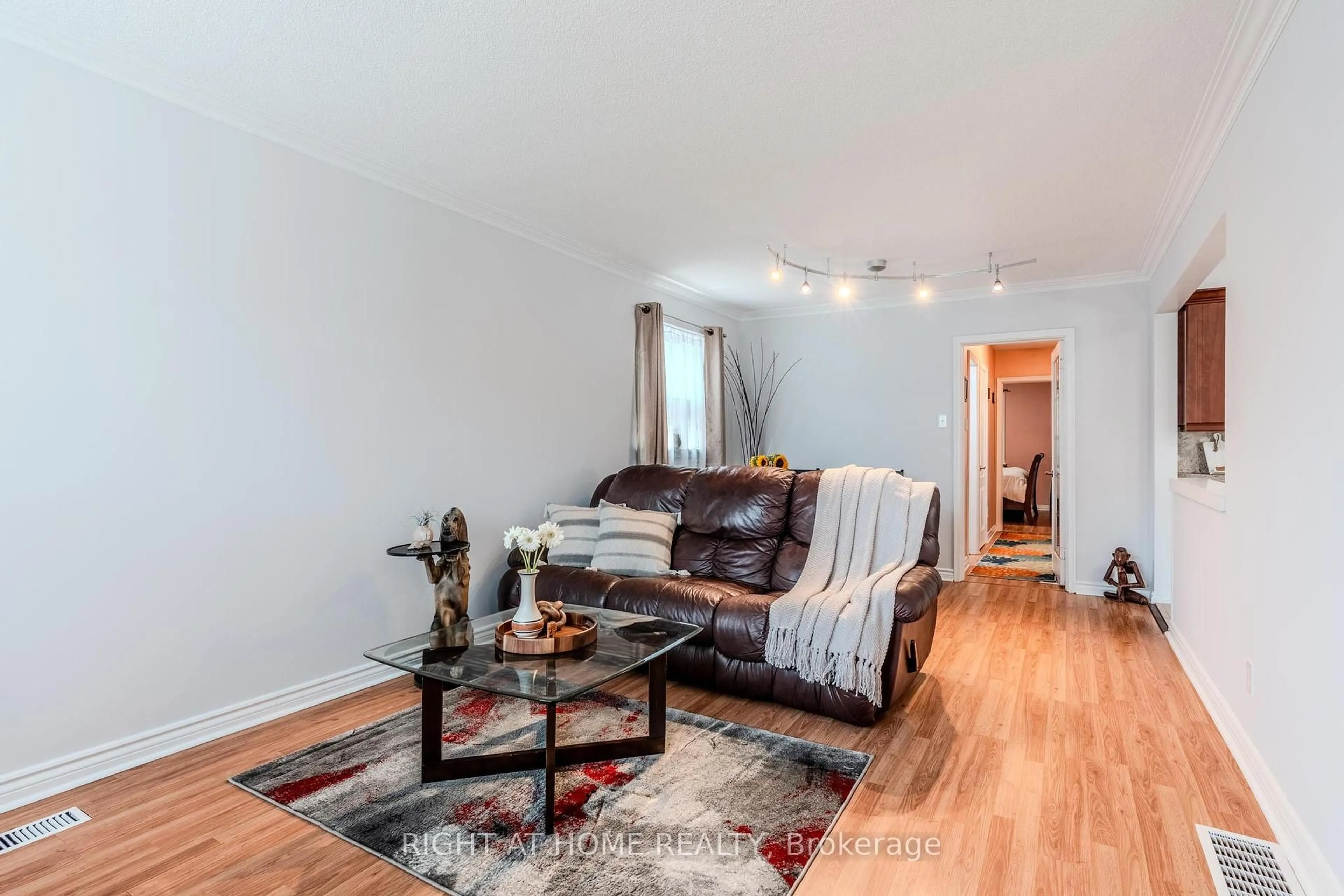 Living room with furniture, wood/laminate floor for 218 South Woodrow Blvd, Toronto Ontario M1N 3L9