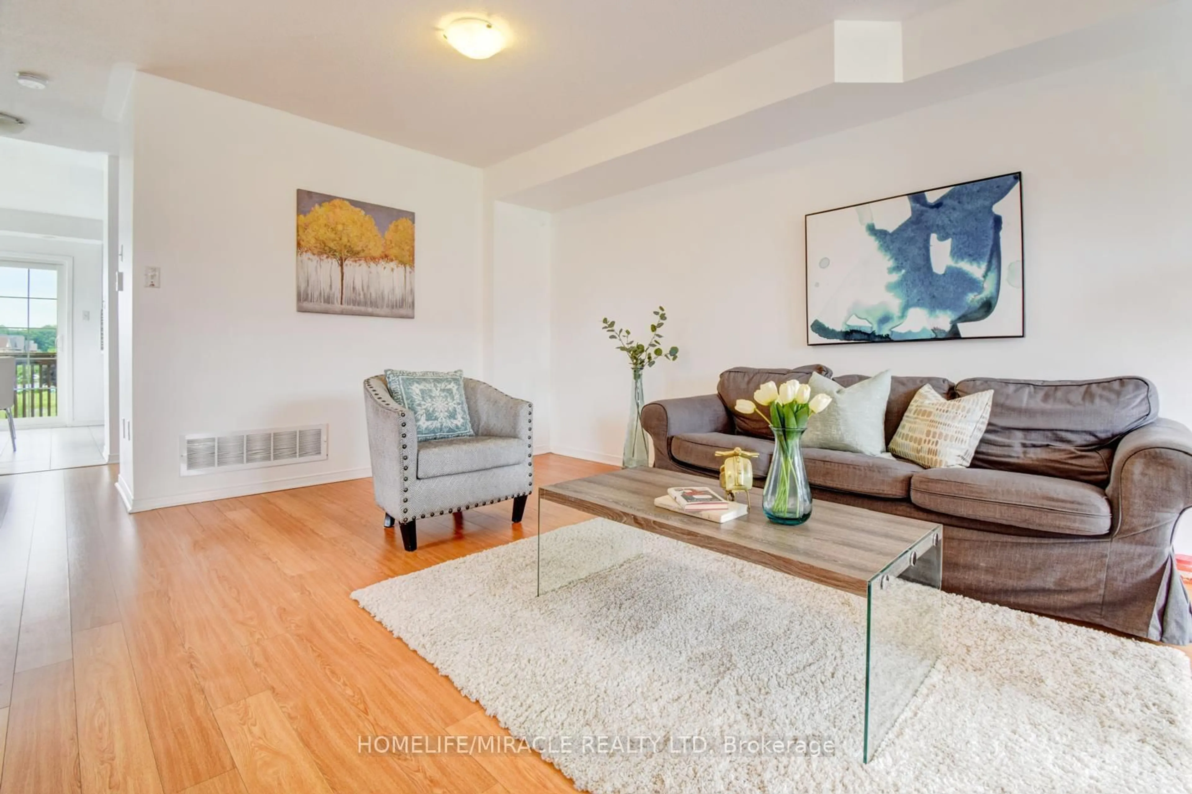 Living room with furniture, wood/laminate floor for 2450 Bromus Path, Oshawa Ontario L1L 0K6