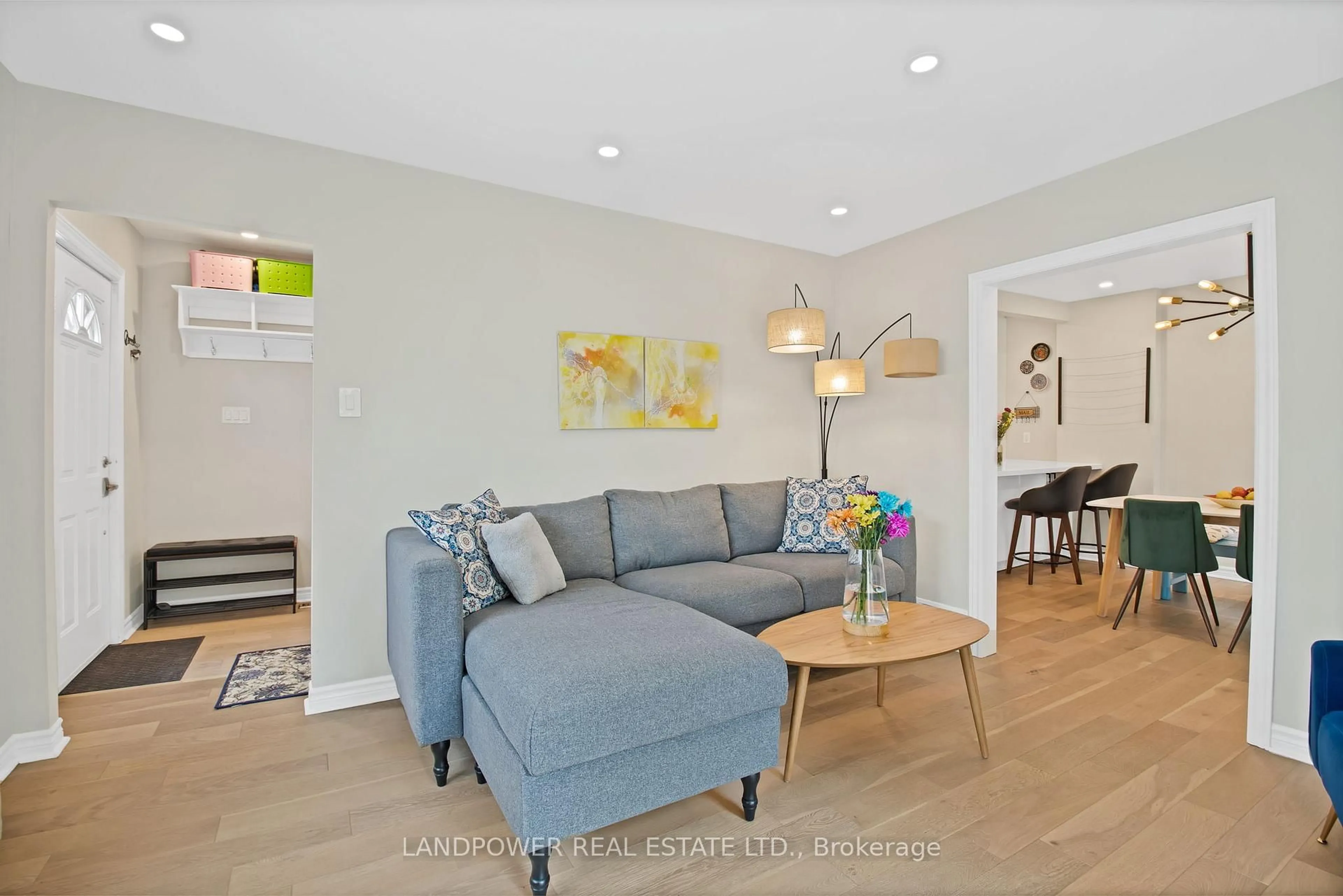 Living room with furniture, wood/laminate floor for 3133 St. Clair Ave, Toronto Ontario M1L 1V2