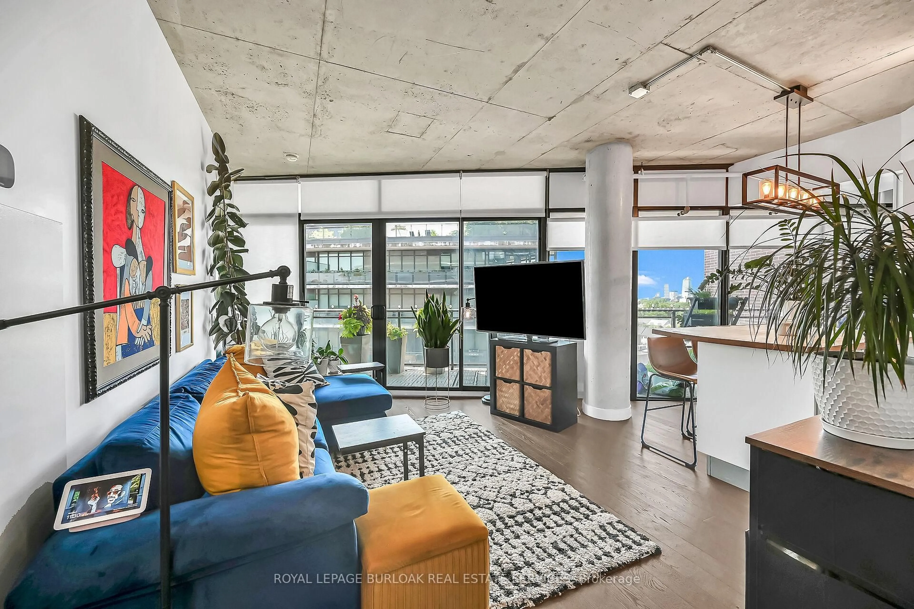 Living room with furniture, cement floor for 1201 Dundas St #902, Toronto Ontario M4M 1S2