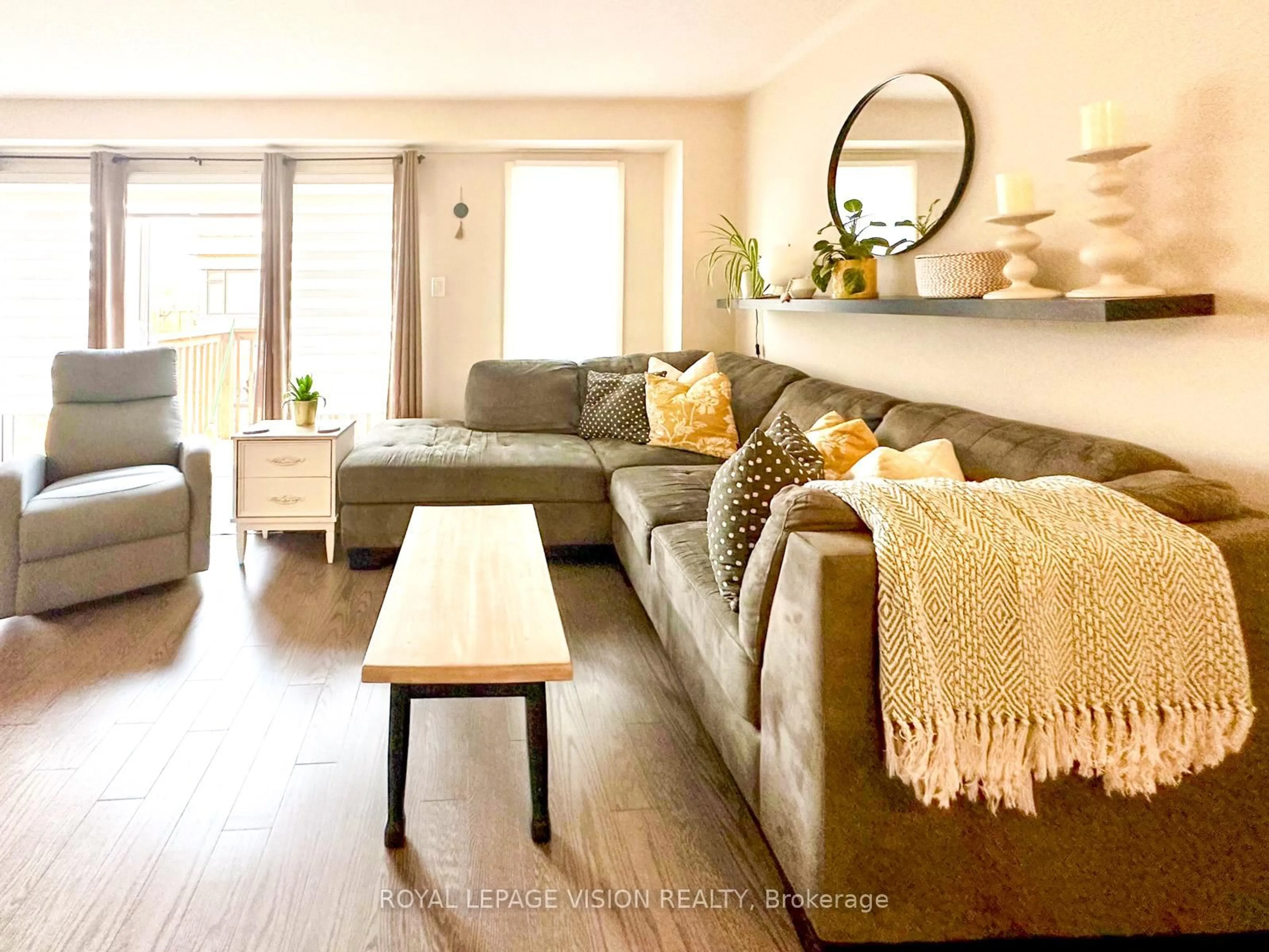 Living room with furniture, wood/laminate floor for 74 Caspian Square Dr, Clarington Ontario L1C 7G4
