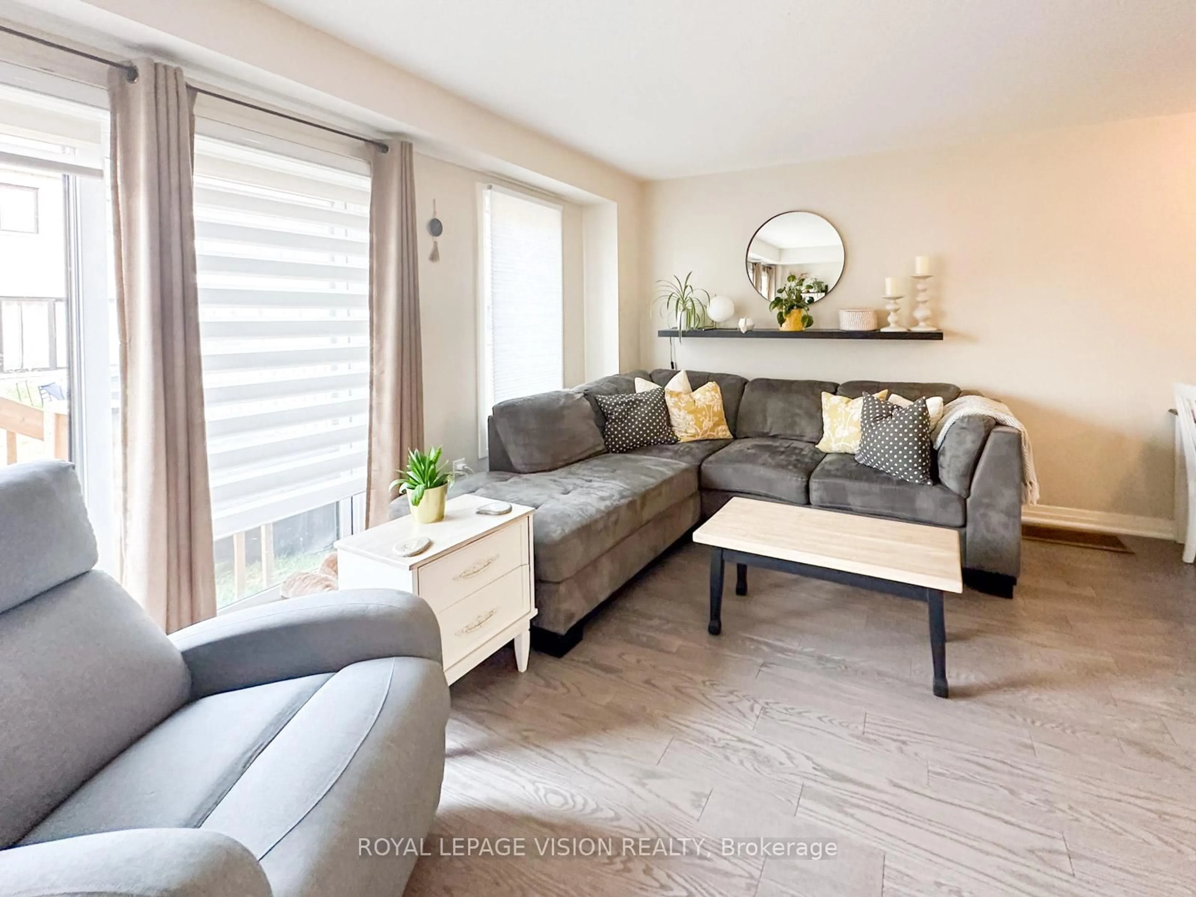 Living room with furniture, wood/laminate floor for 74 Caspian Square Dr, Clarington Ontario L1C 7G4