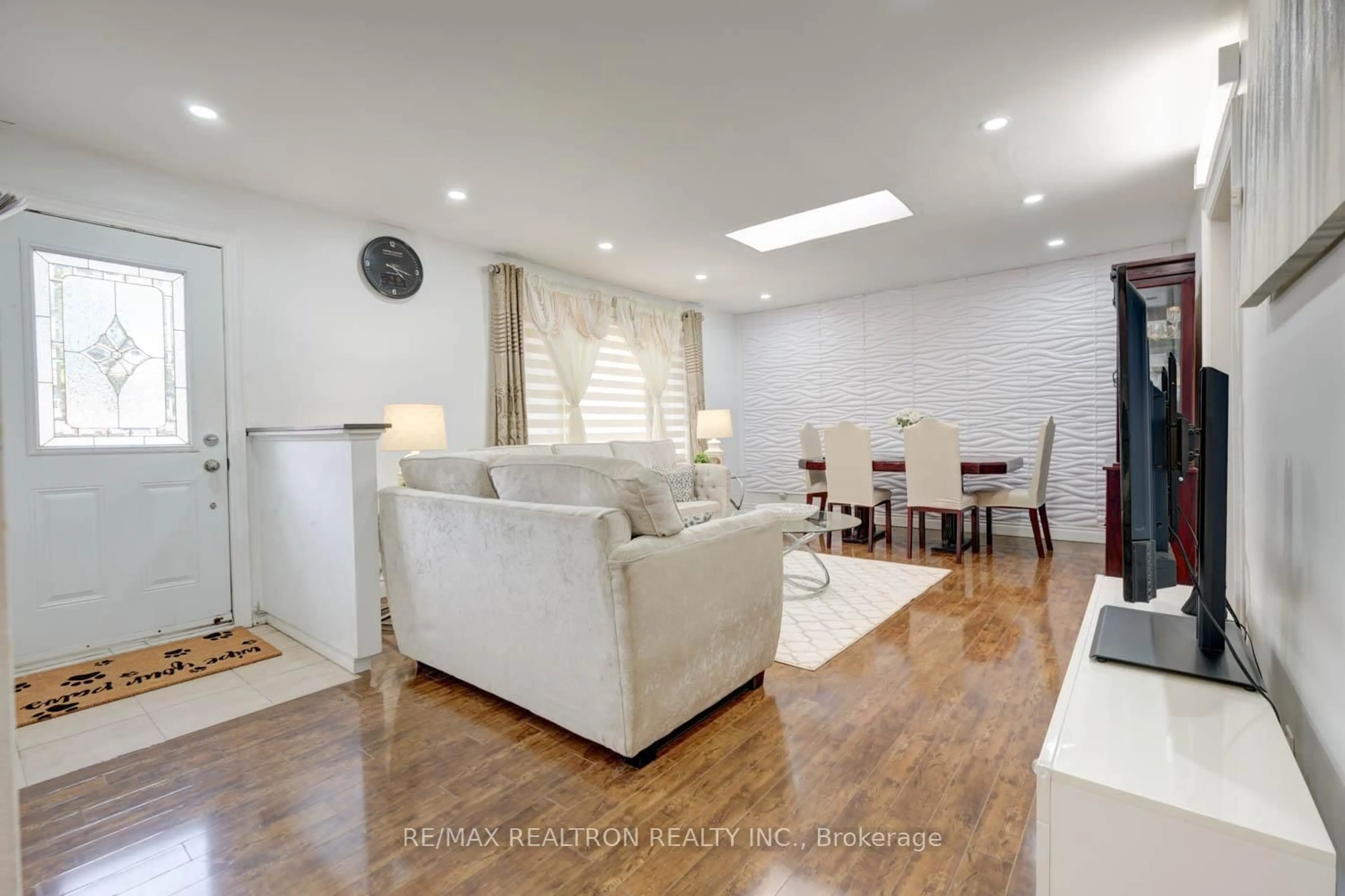 Living room with furniture, wood/laminate floor for 3853 Finch Ave, Toronto Ontario M1T 3G1