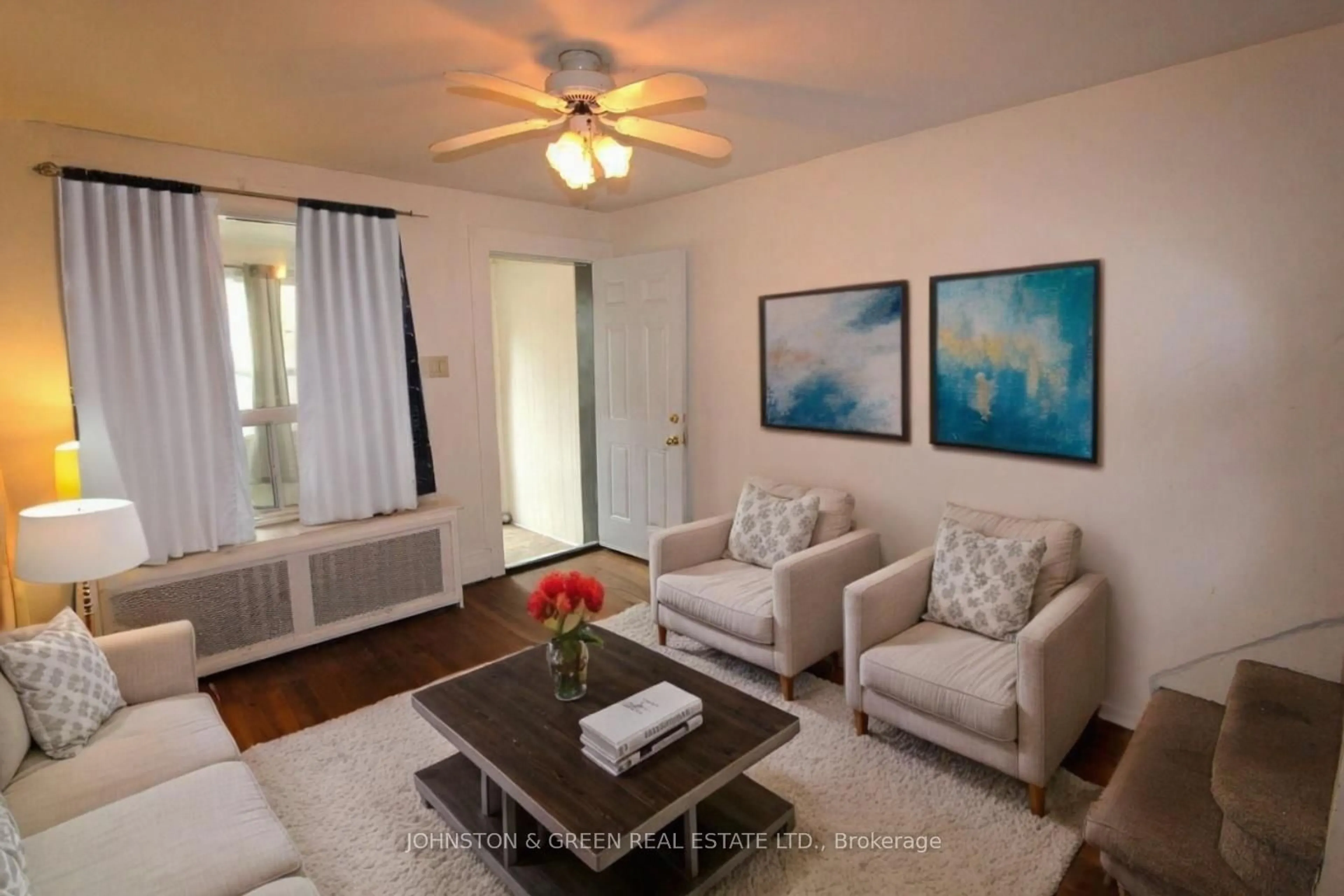 Living room with furniture, wood/laminate floor for 799 Sammon Ave, Toronto Ontario M4C 2E7