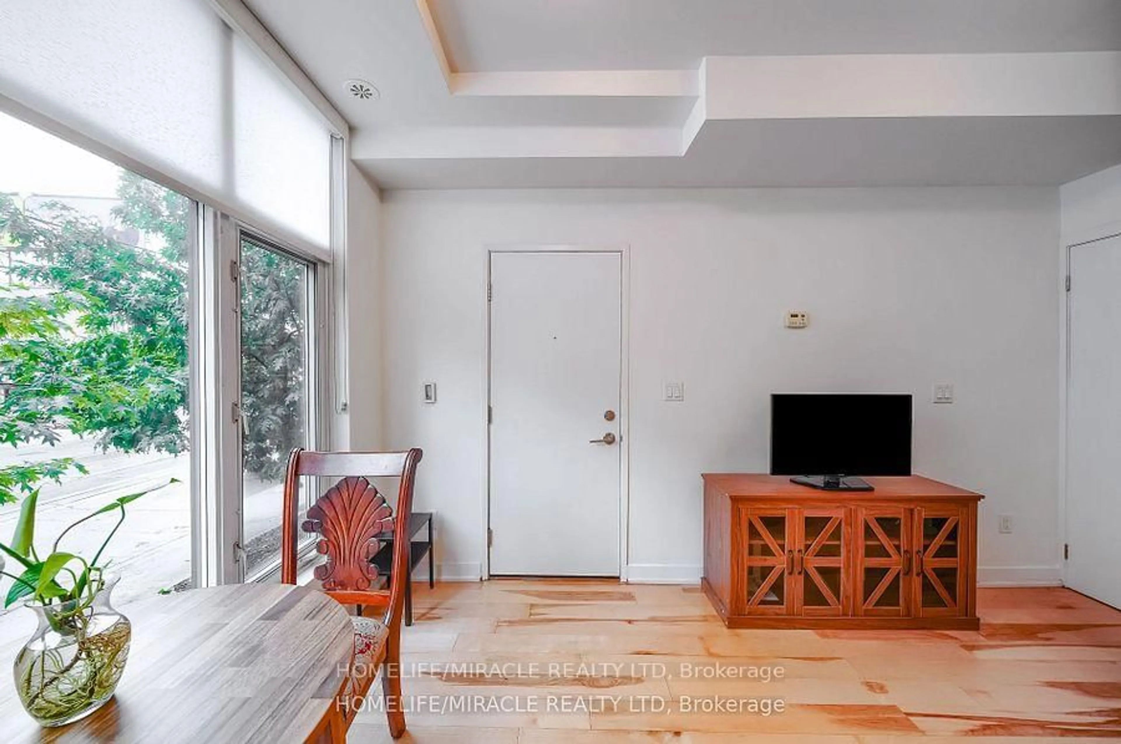 Living room with furniture, wood/laminate floor for 1331 Gerrard St #2, Toronto Ontario M4L 1Y8