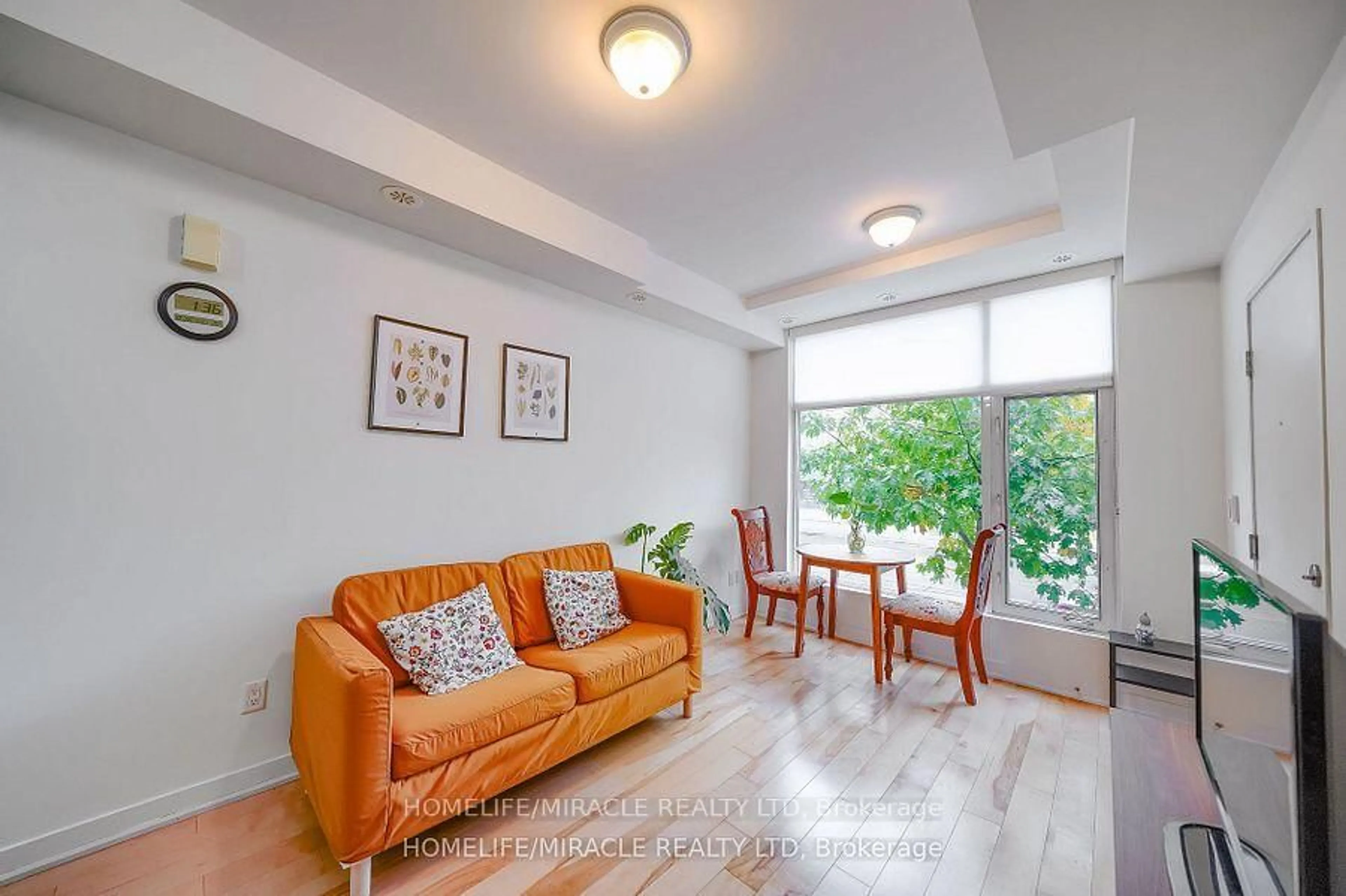 Living room with furniture, wood/laminate floor for 1331 Gerrard St #2, Toronto Ontario M4L 1Y8