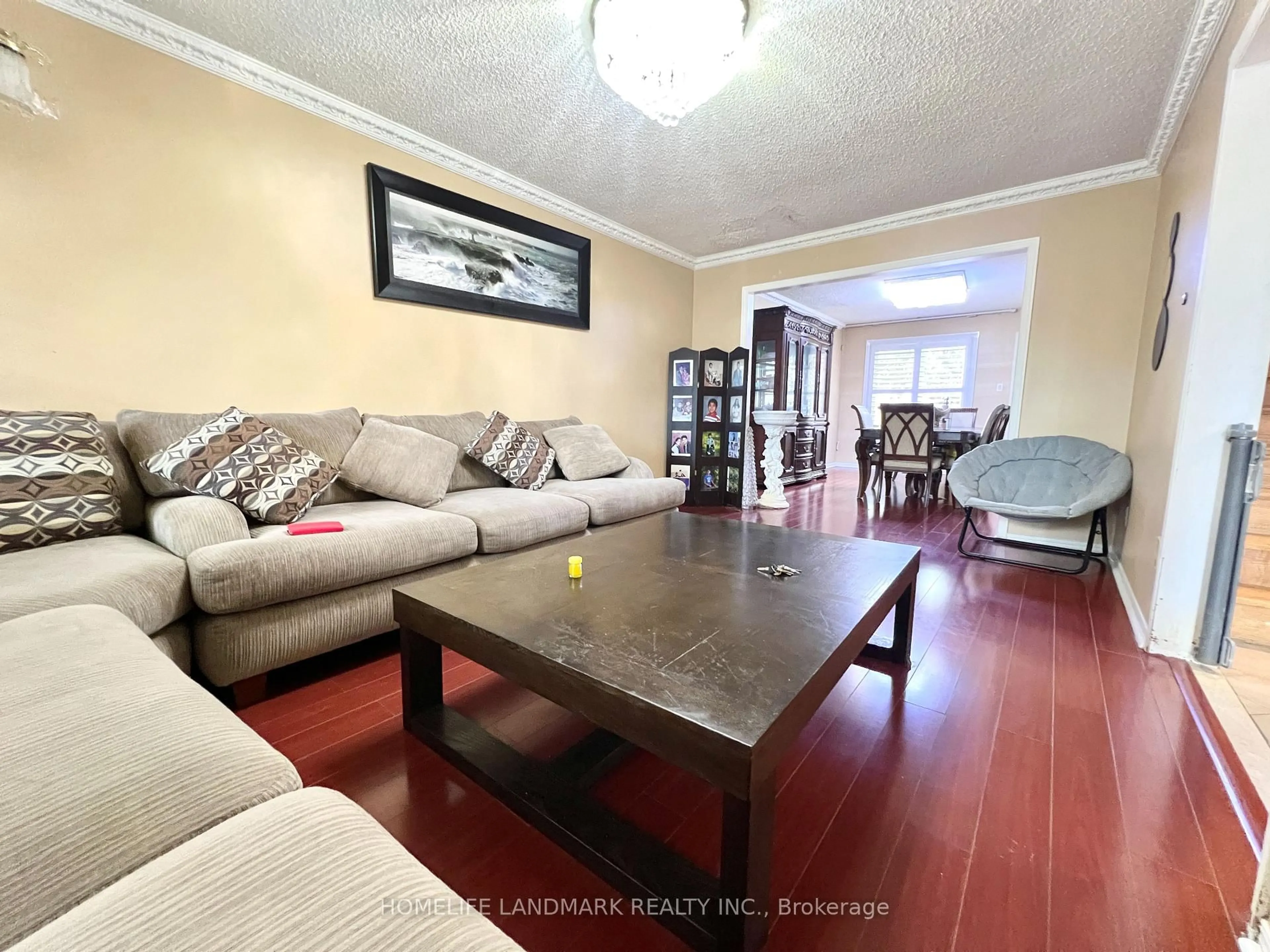 Living room with furniture, wood/laminate floor for 327 Goldhawk Tr, Toronto Ontario M1V 4H2