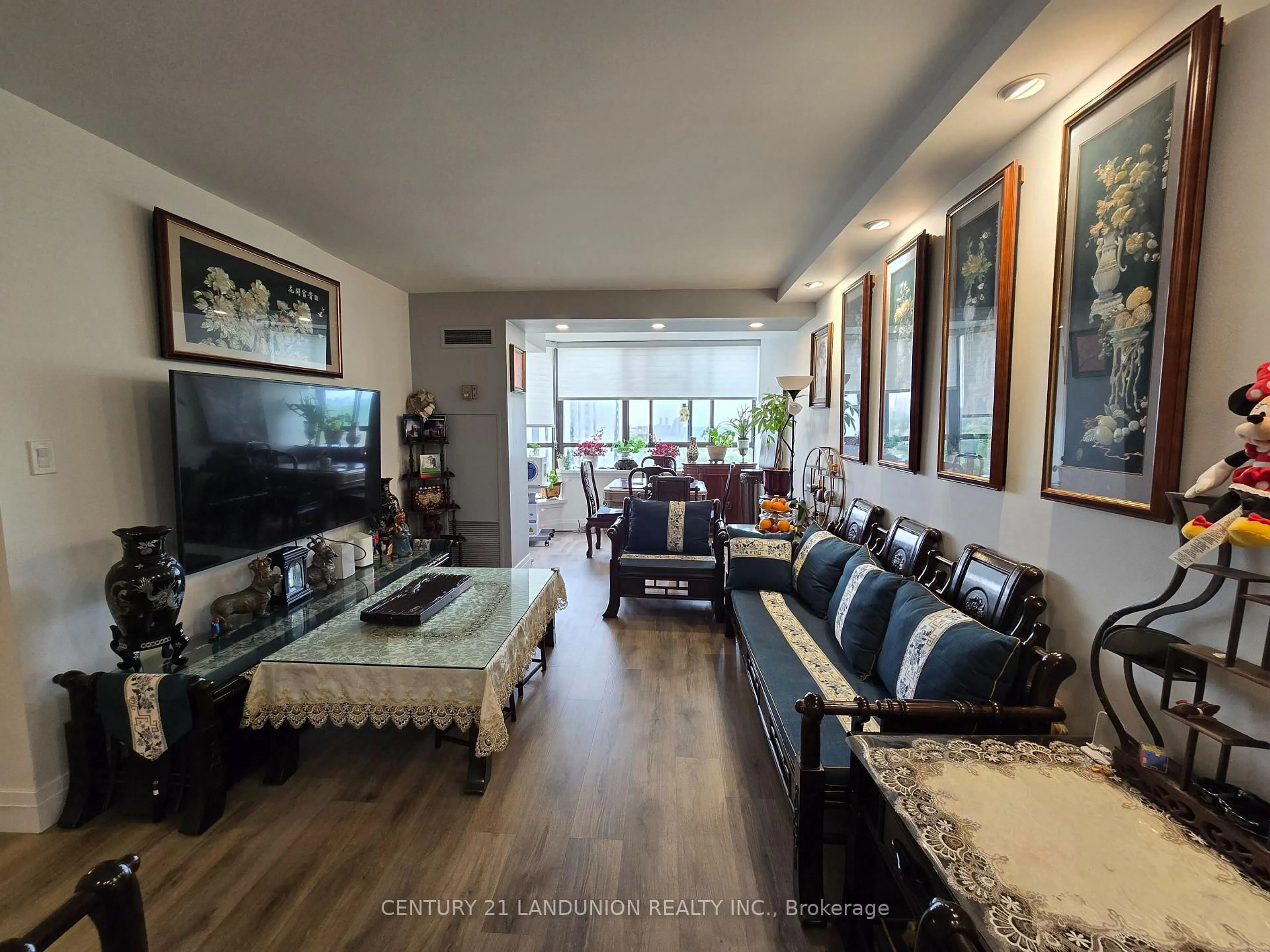 Living room with furniture, wood/laminate floor for 55 Bamburgh Circ #1209, Toronto Ontario M1W 3V4