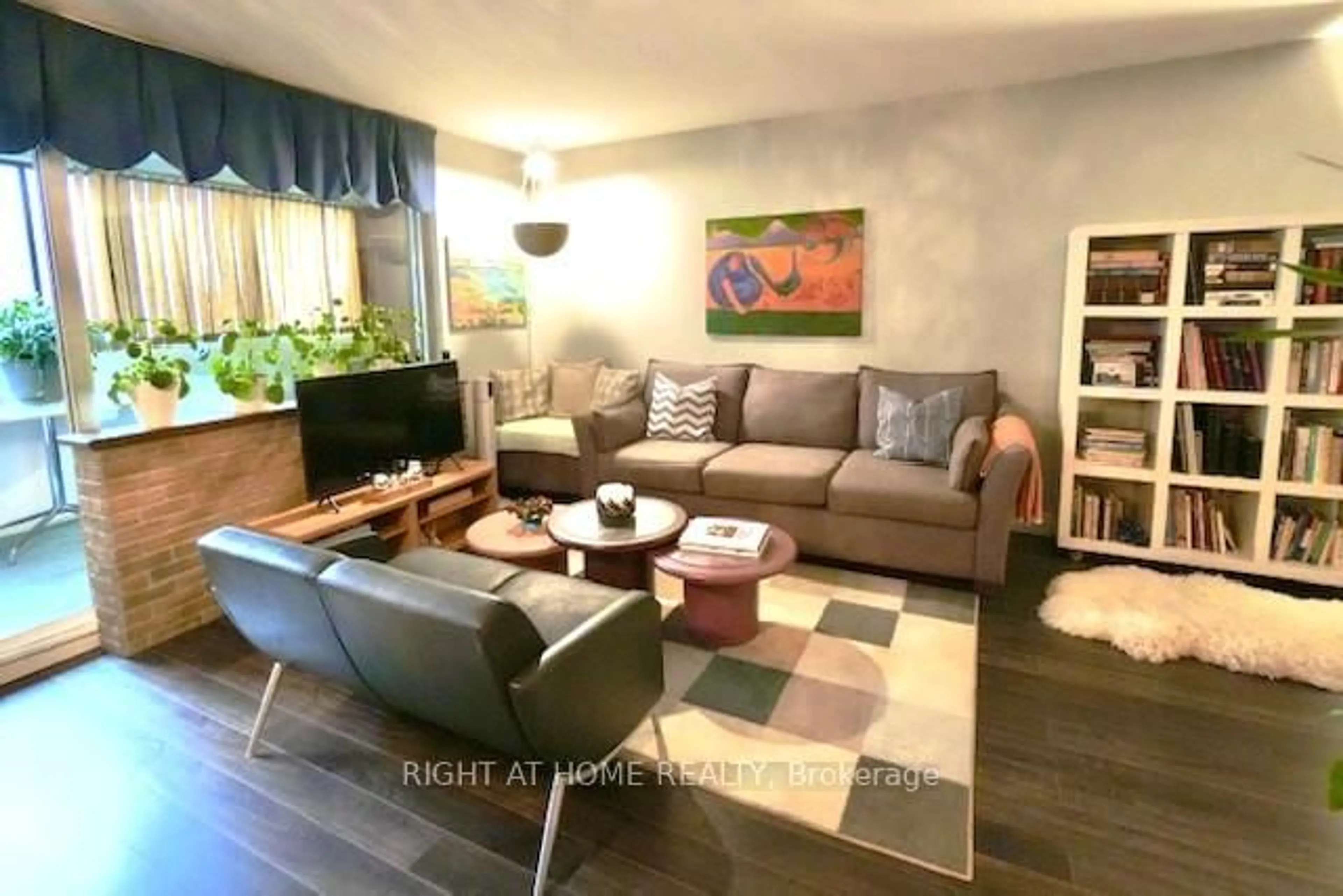 Living room with furniture, wood/laminate floor for 5 Massey Sq #411, Toronto Ontario M4C 5L6