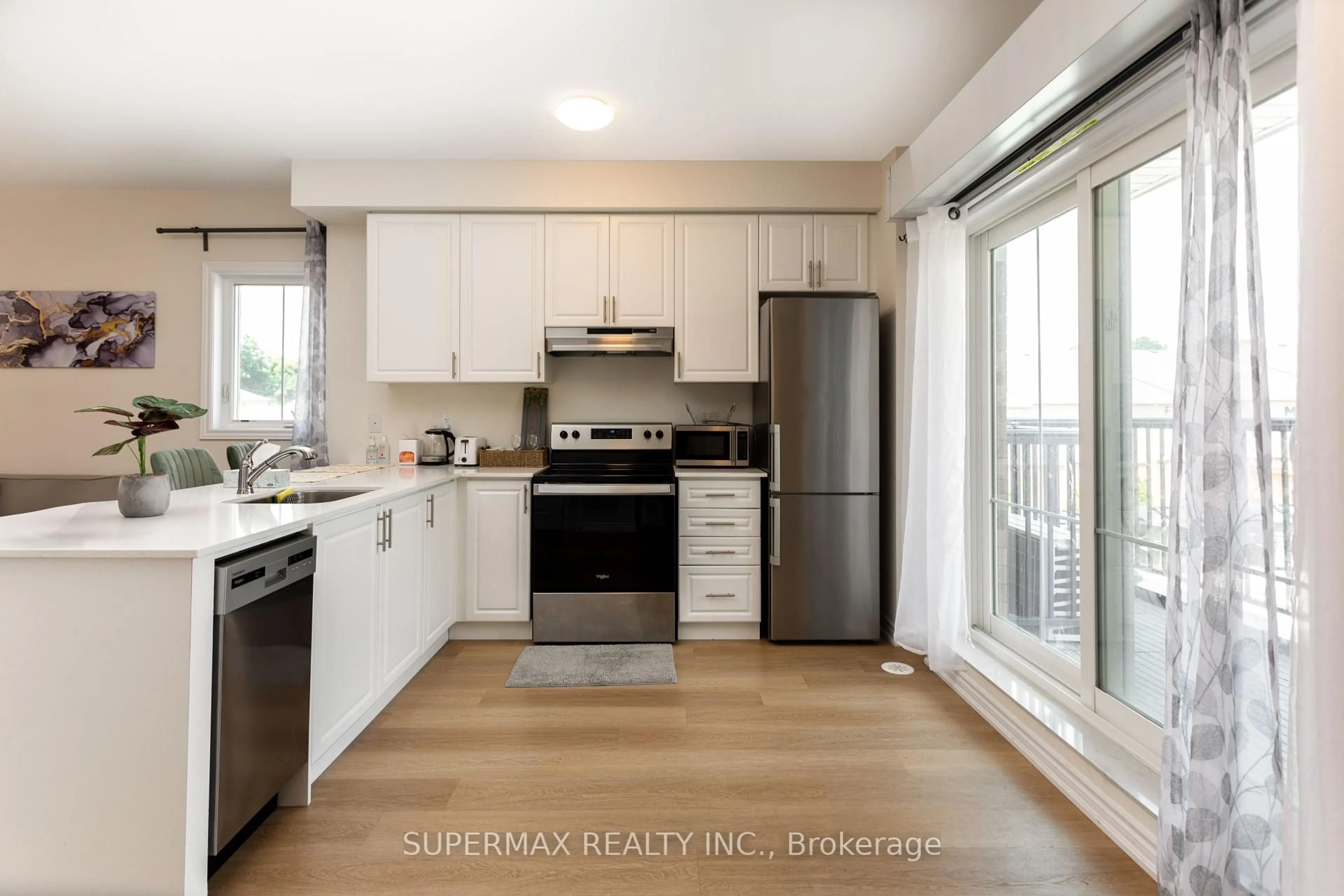 Open concept kitchen, wood/laminate floor for 470 Beresford Path #10, Oshawa Ontario L1H 5S7