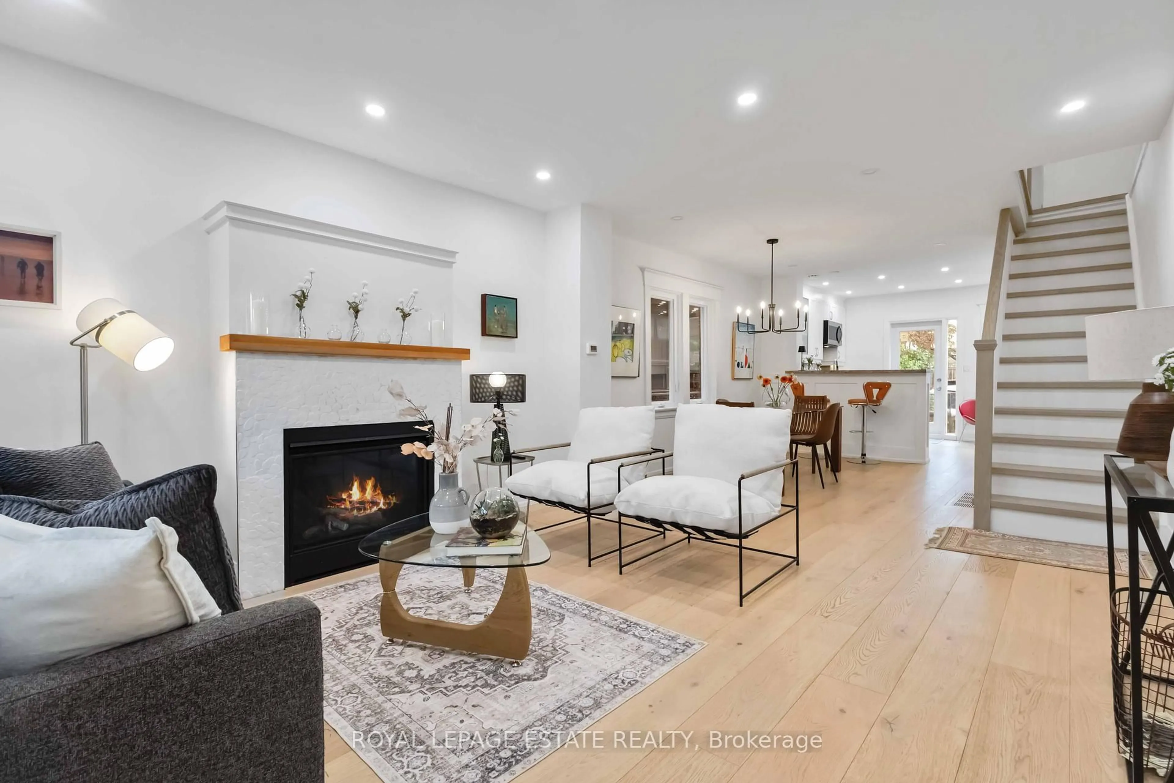 Living room with furniture, wood/laminate floor for 42 Chatham Ave, Toronto Ontario M4J 1K6