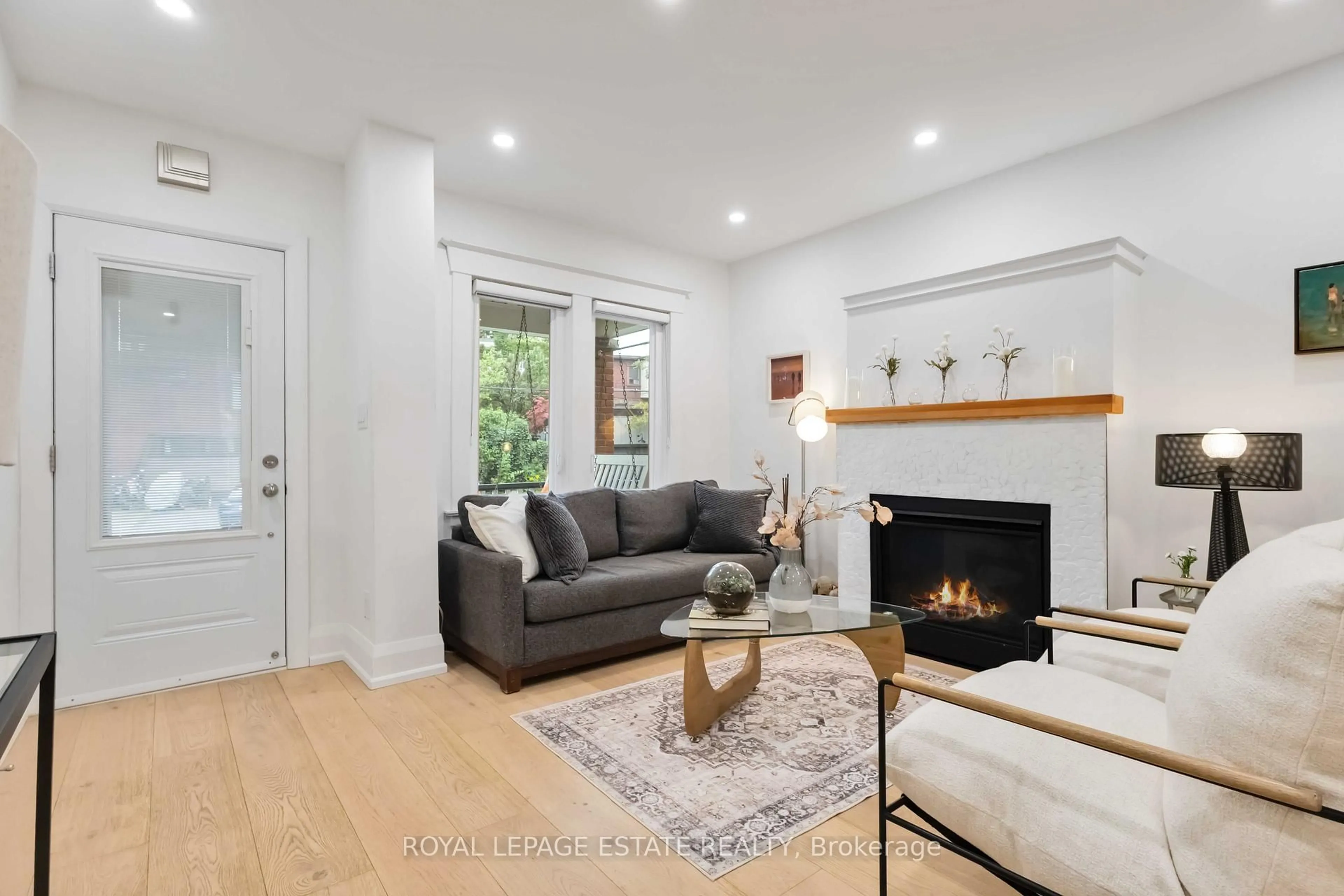Living room with furniture, wood/laminate floor for 42 Chatham Ave, Toronto Ontario M4J 1K6