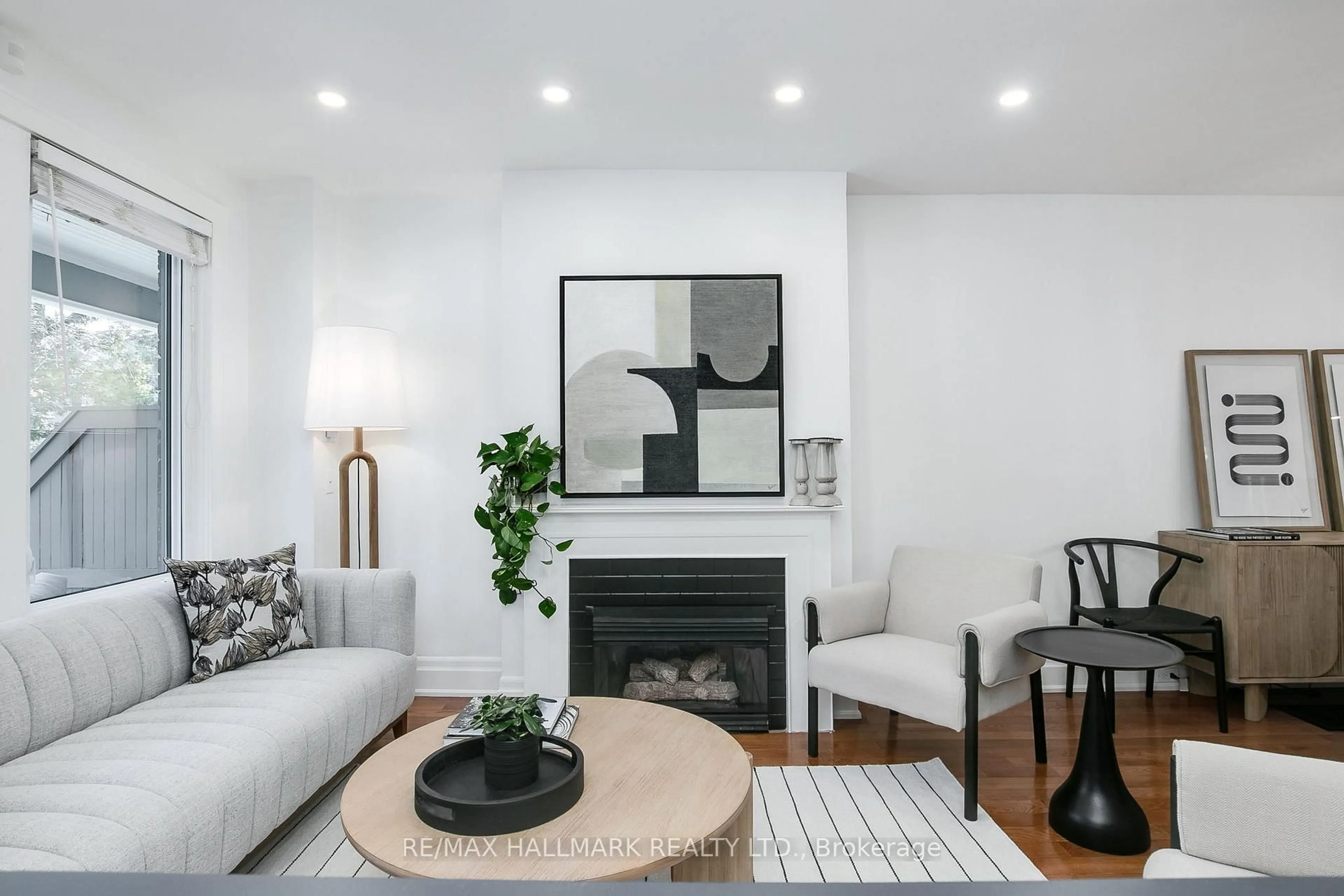 Living room with furniture, wood/laminate floor for 144 Langford Ave, Toronto Ontario M4J 3E3