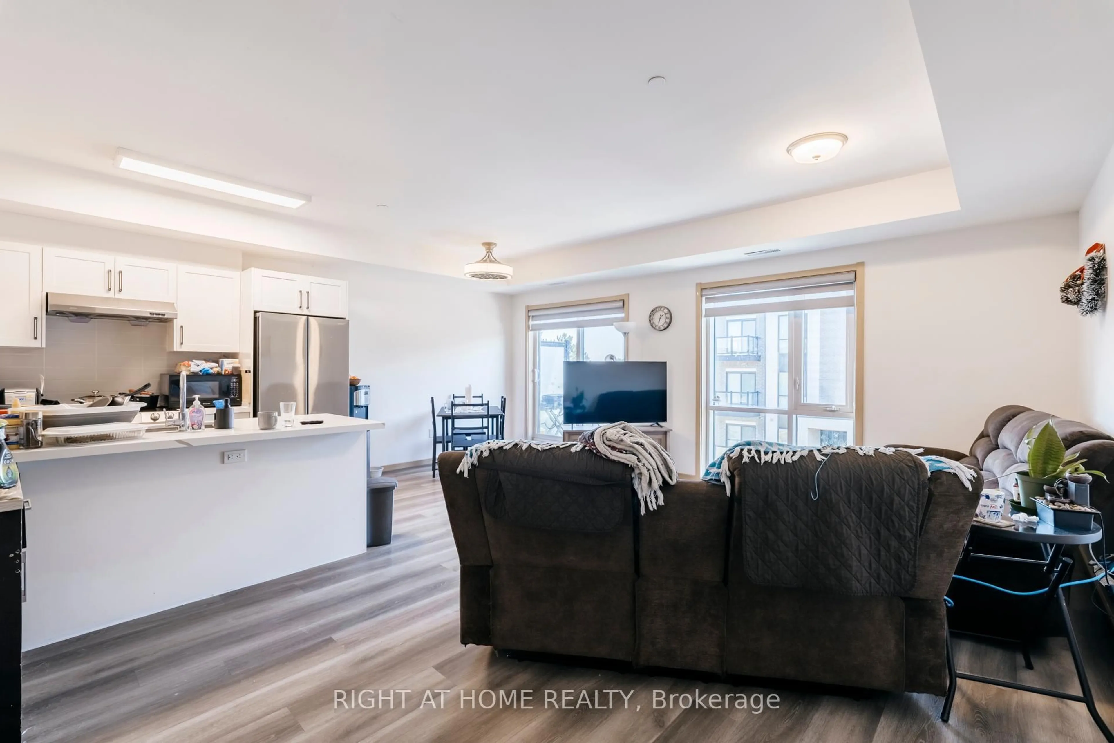 Living room with furniture, wood/laminate floor for 200 Chester Le Blvd #D302, Toronto Ontario M1W 0A9