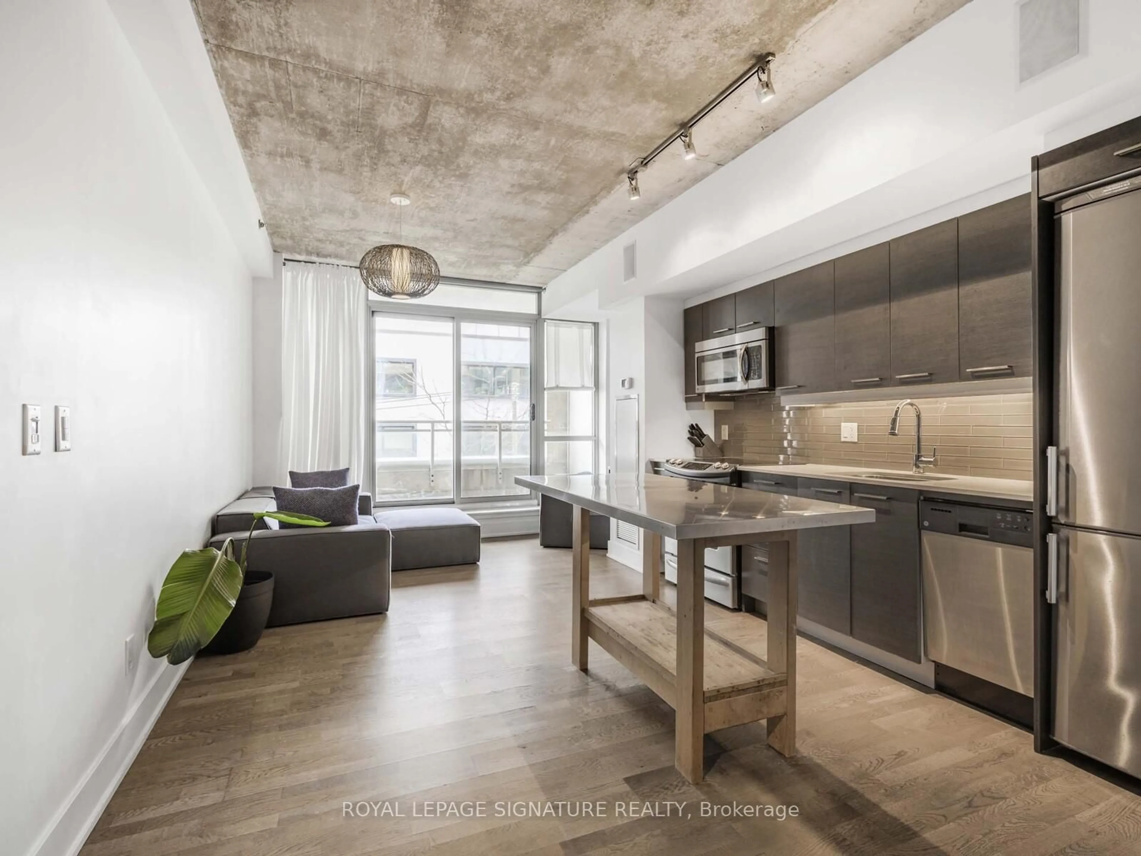 Open concept kitchen, cement floor for 630 Queen St #217, Toronto Ontario M4M 1G3