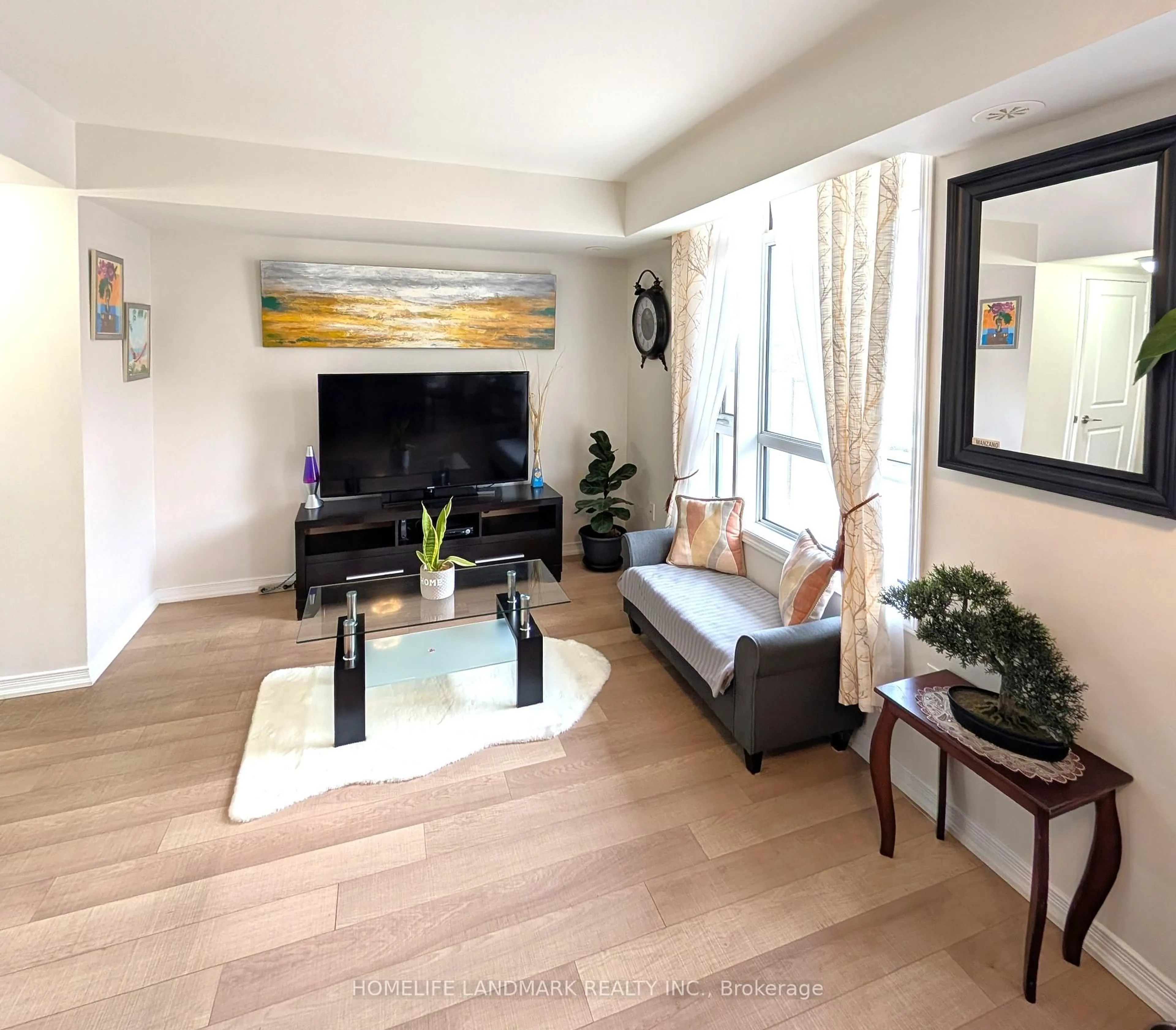 Living room with furniture, wood/laminate floor for 80 Orchid Place Dr #312, Toronto Ontario M1B 0C4
