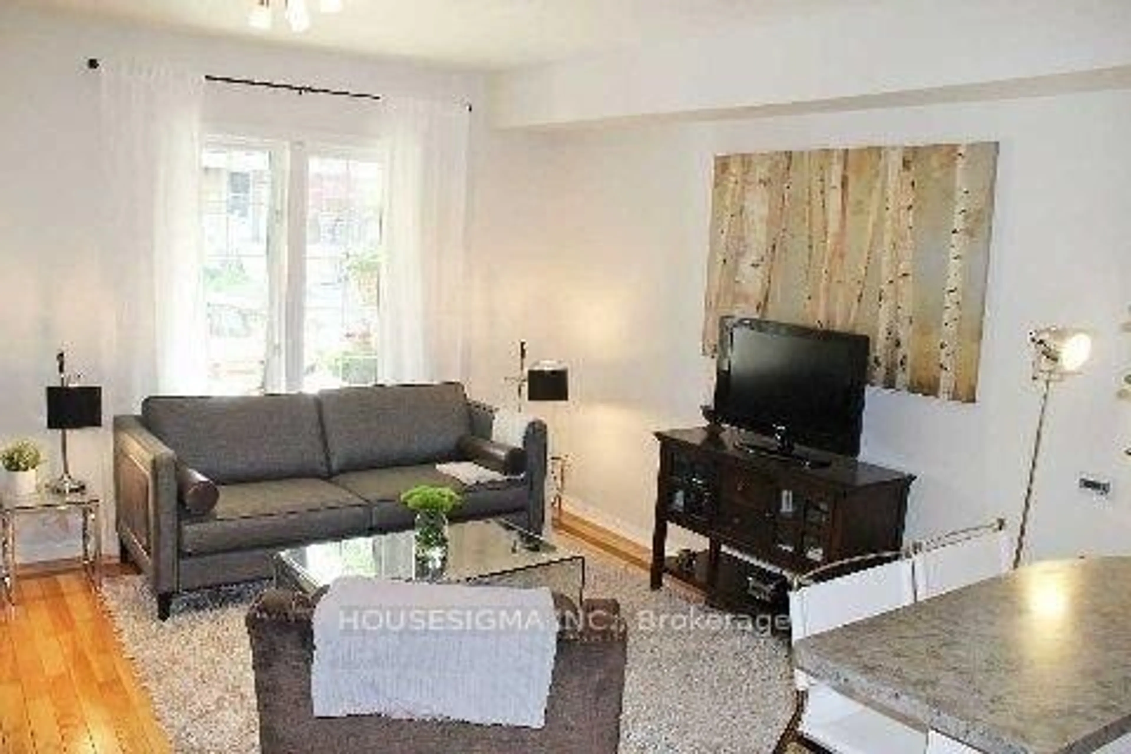 Living room with furniture, wood/laminate floor for 184 Bellefair Ave, Toronto Ontario M4L 3T9