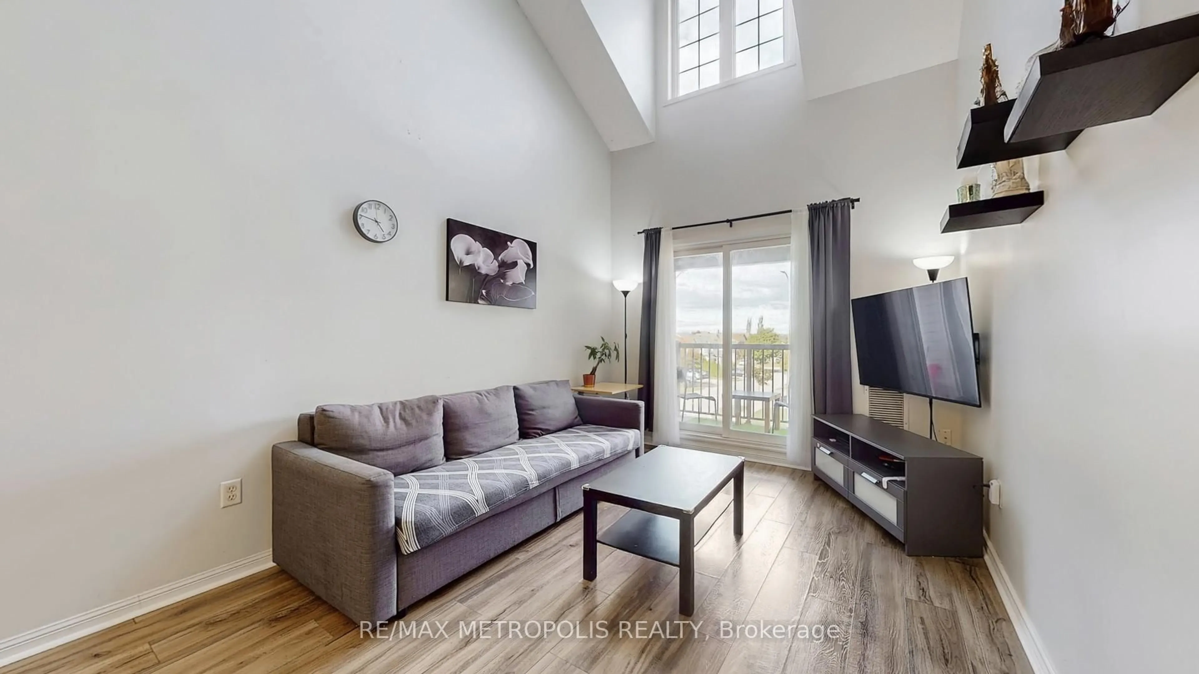 Living room with furniture, wood/laminate floor for 72 Petra Way #3, Whitby Ontario L1R 0A3