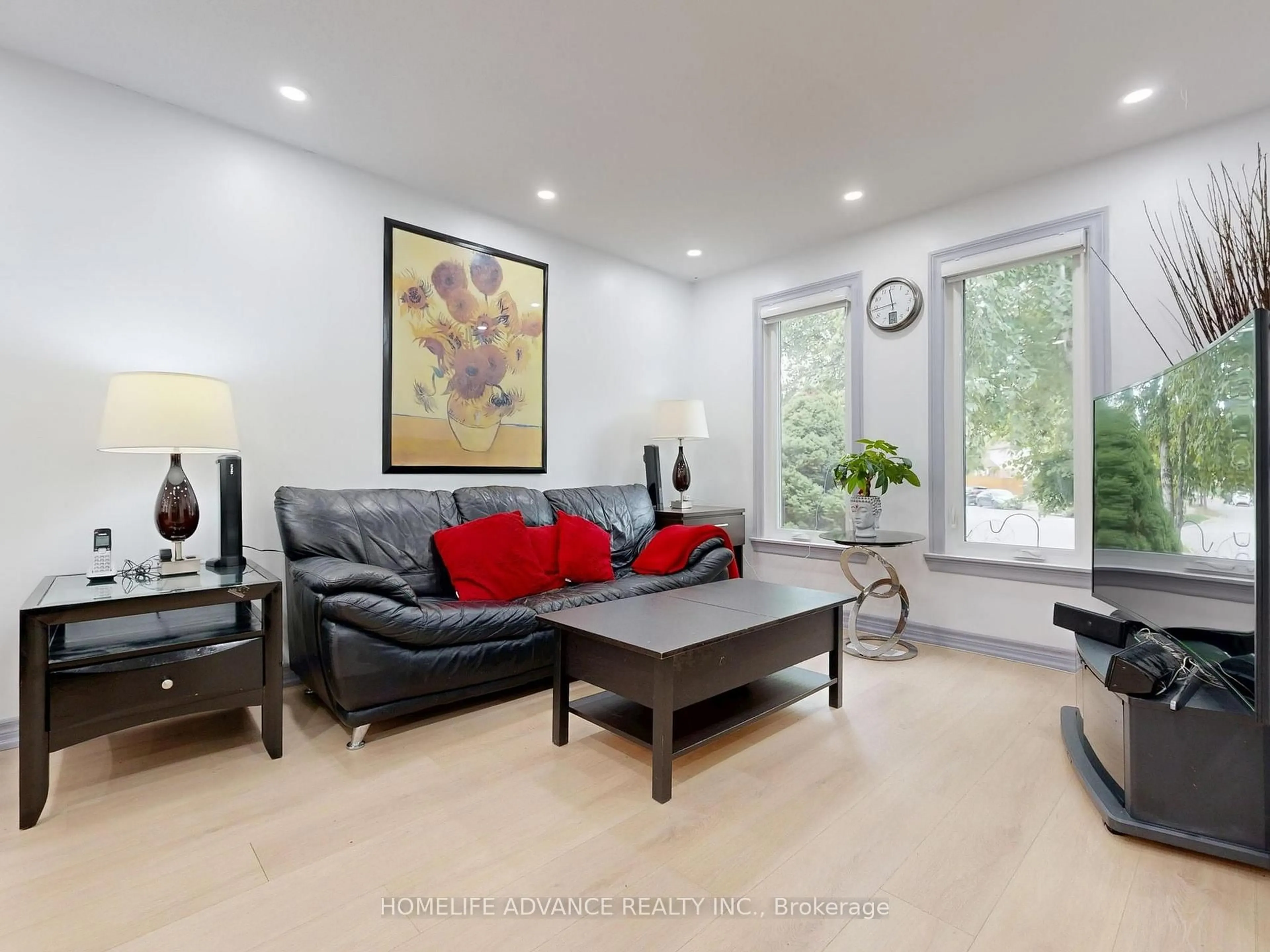 Living room with furniture, wood/laminate floor for 75 Mossbrook Cres, Toronto Ontario M1W 2W8