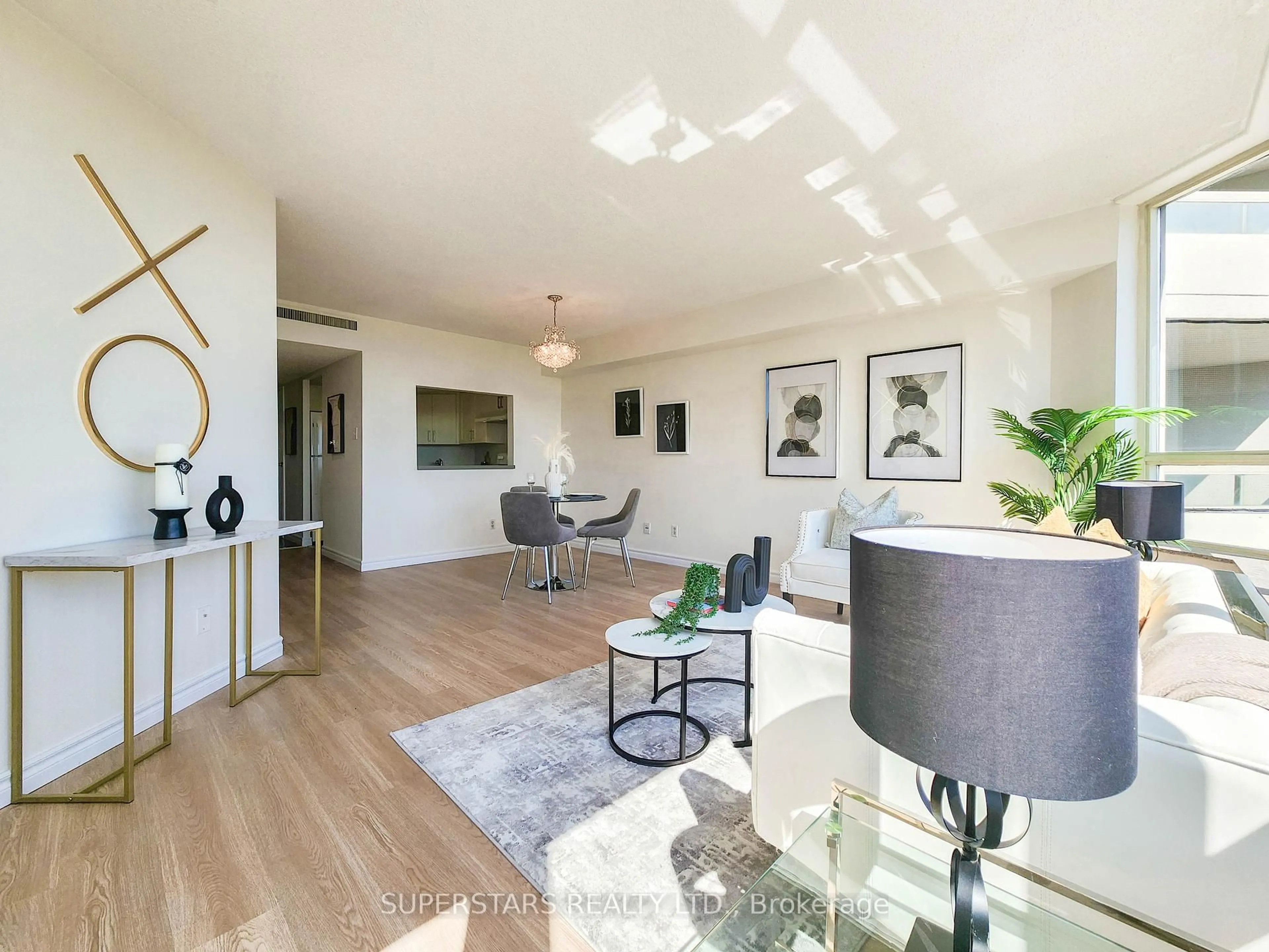 Living room with furniture, wood/laminate floor for 150 Alton Towers Circ #813, Toronto Ontario M1V 4X7