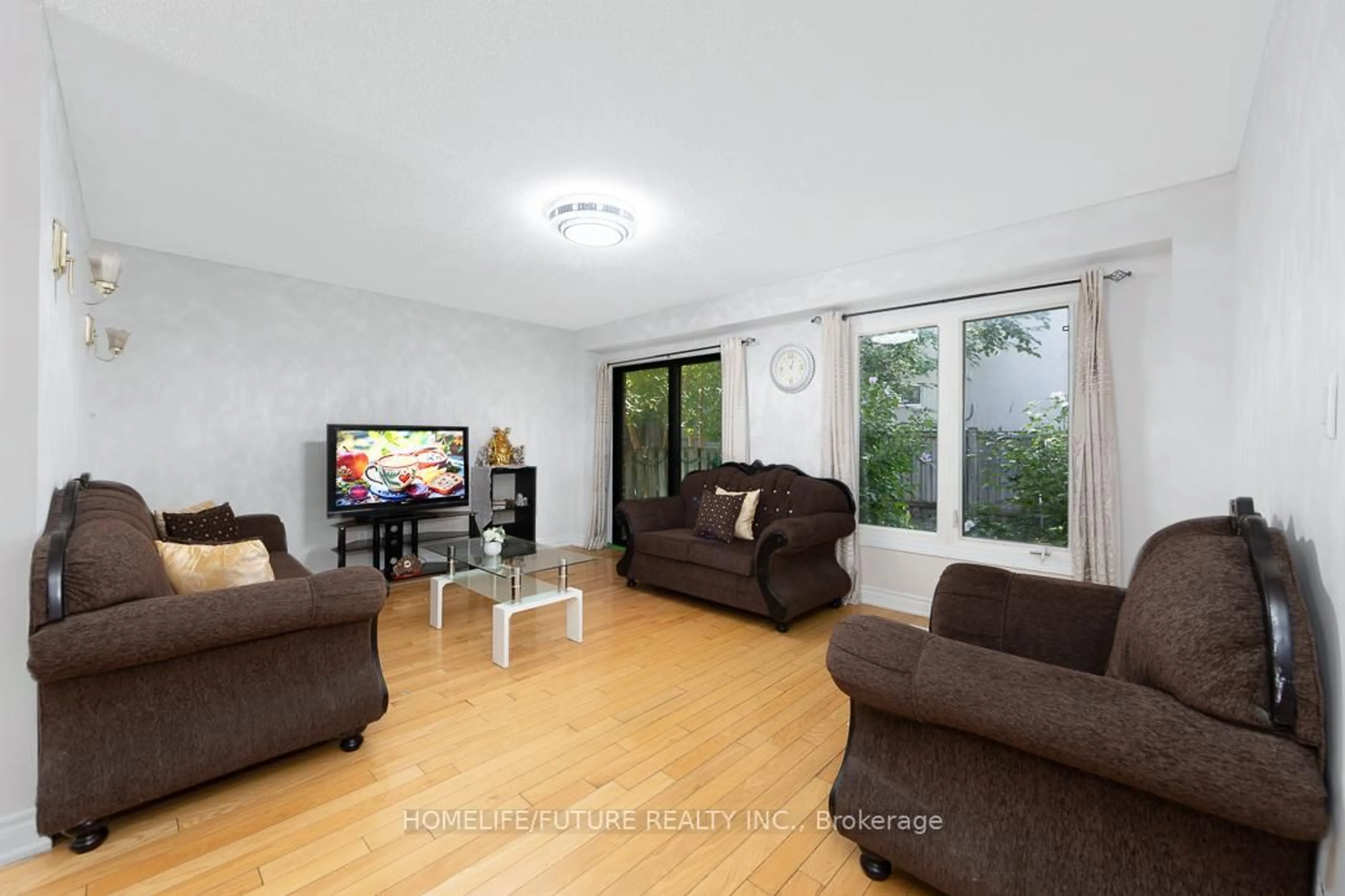 Living room with furniture, wood/laminate floor for 67 Verne Cres, Toronto Ontario M1B 2Y4