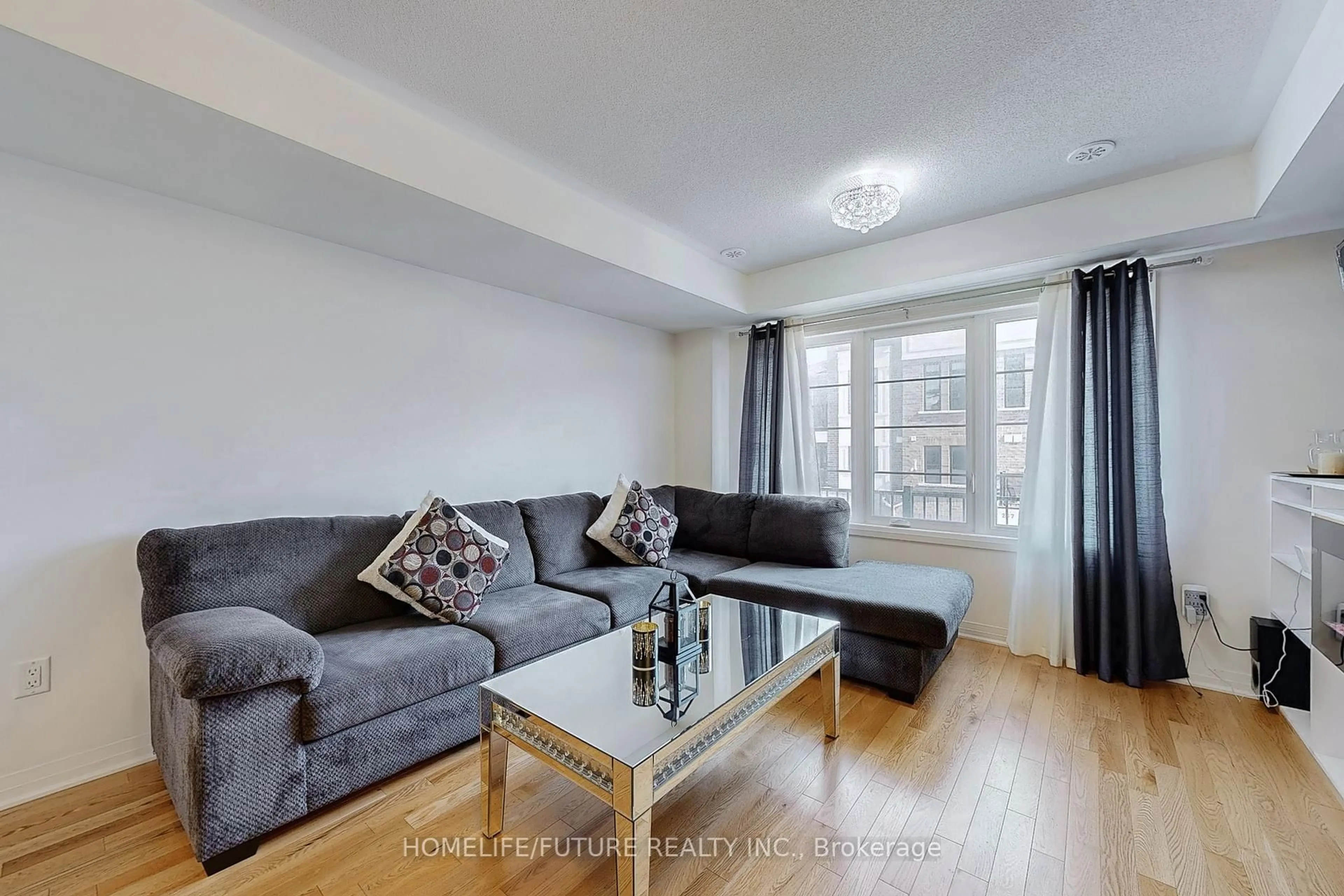 Living room with furniture, wood/laminate floor for 224 Lord Elgin Lane, Clarington Ontario L1C 7E8