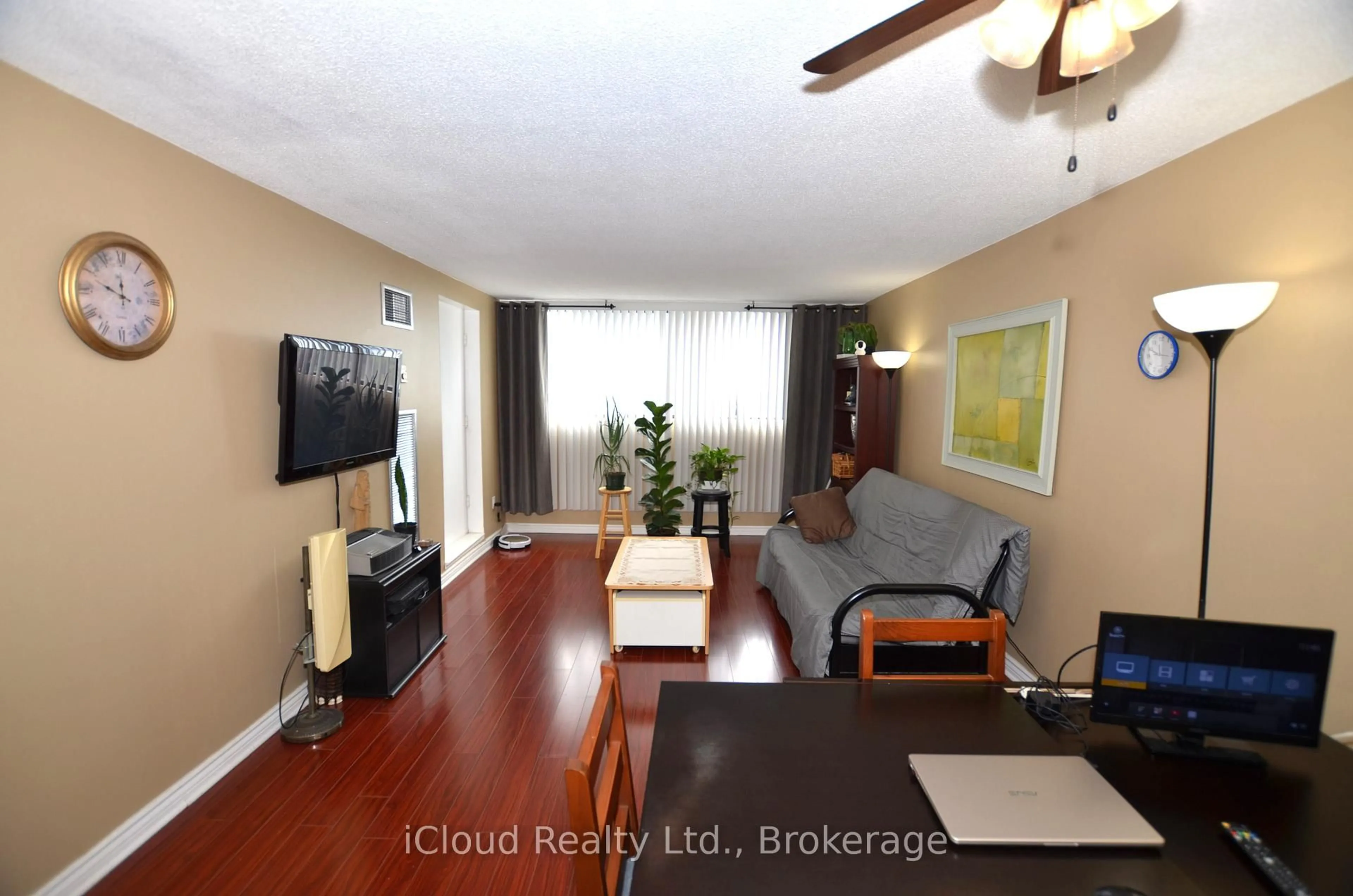 Living room with furniture, wood/laminate floor for 10 Tapscott Rd #1213, Toronto Ontario M1B 3L9