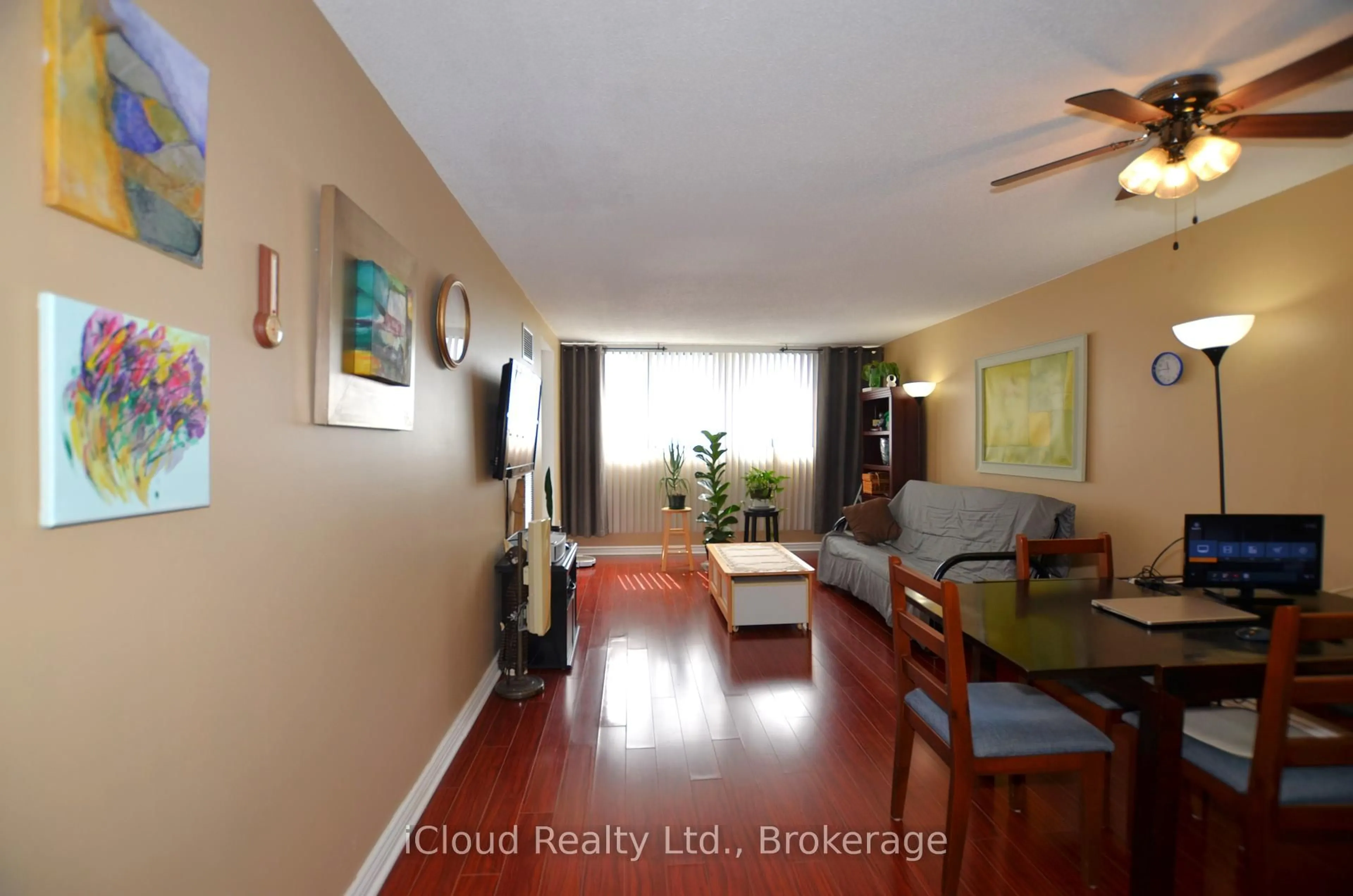 Living room with furniture, wood/laminate floor for 10 Tapscott Rd #1213, Toronto Ontario M1B 3L9