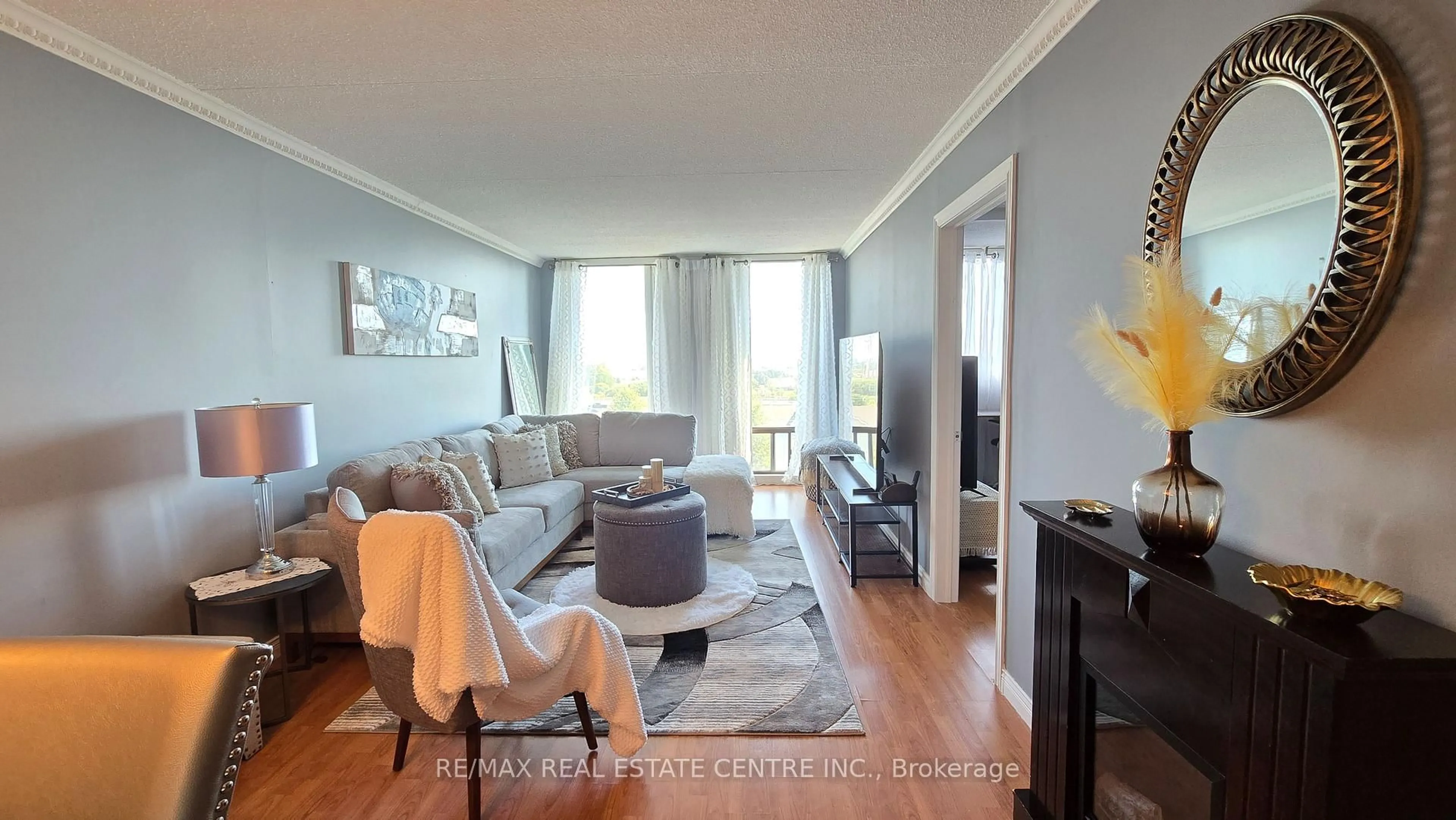 Living room with furniture, wood/laminate floor for 1540 Pickering Pkwy #609, Pickering Ontario L1V 3V9