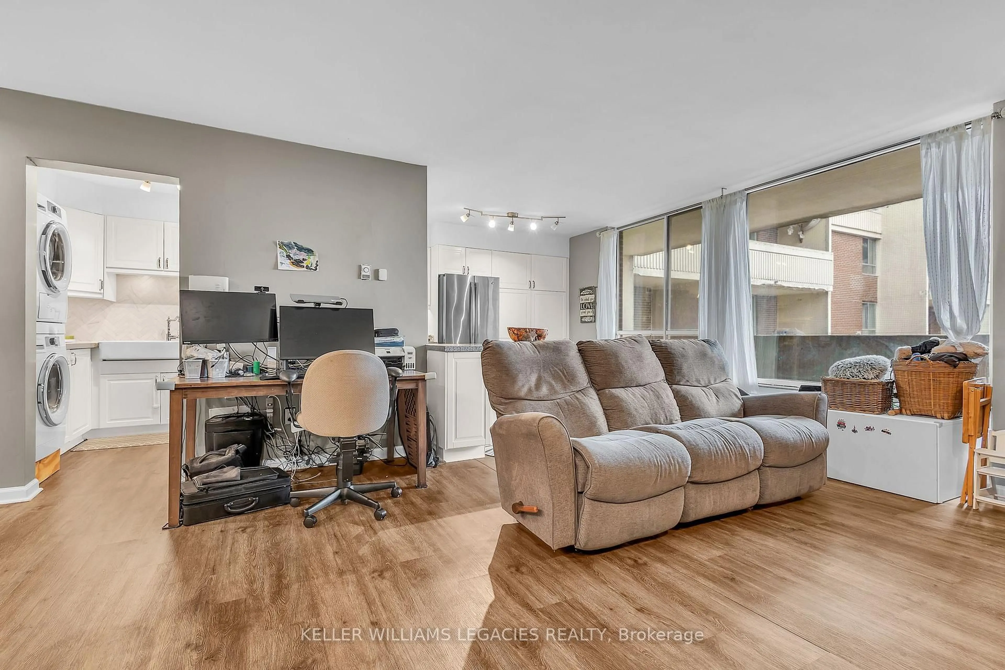 Living room with furniture, wood/laminate floor for 1 Massey Sq #2001, Toronto Ontario M4C 5L4