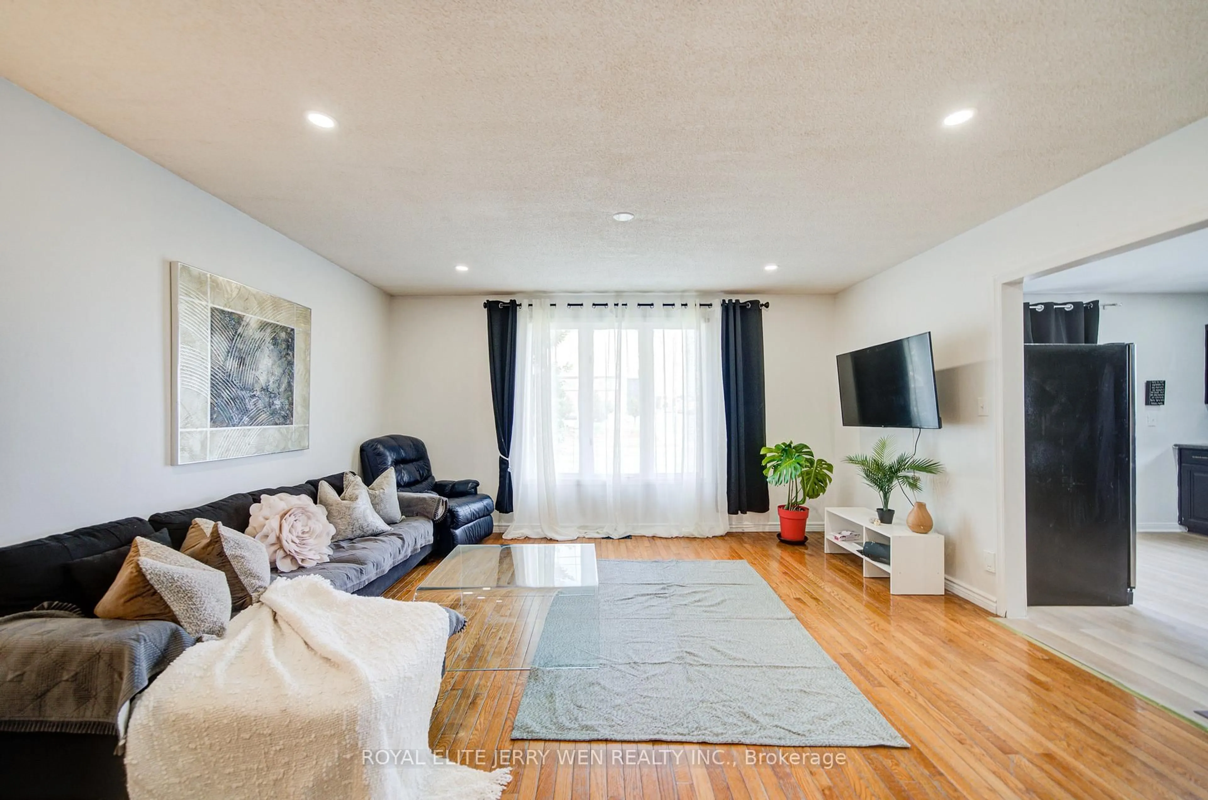 Living room with furniture, wood/laminate floor for 1402 Wilson Rd, Oshawa Ontario L1K 2B9