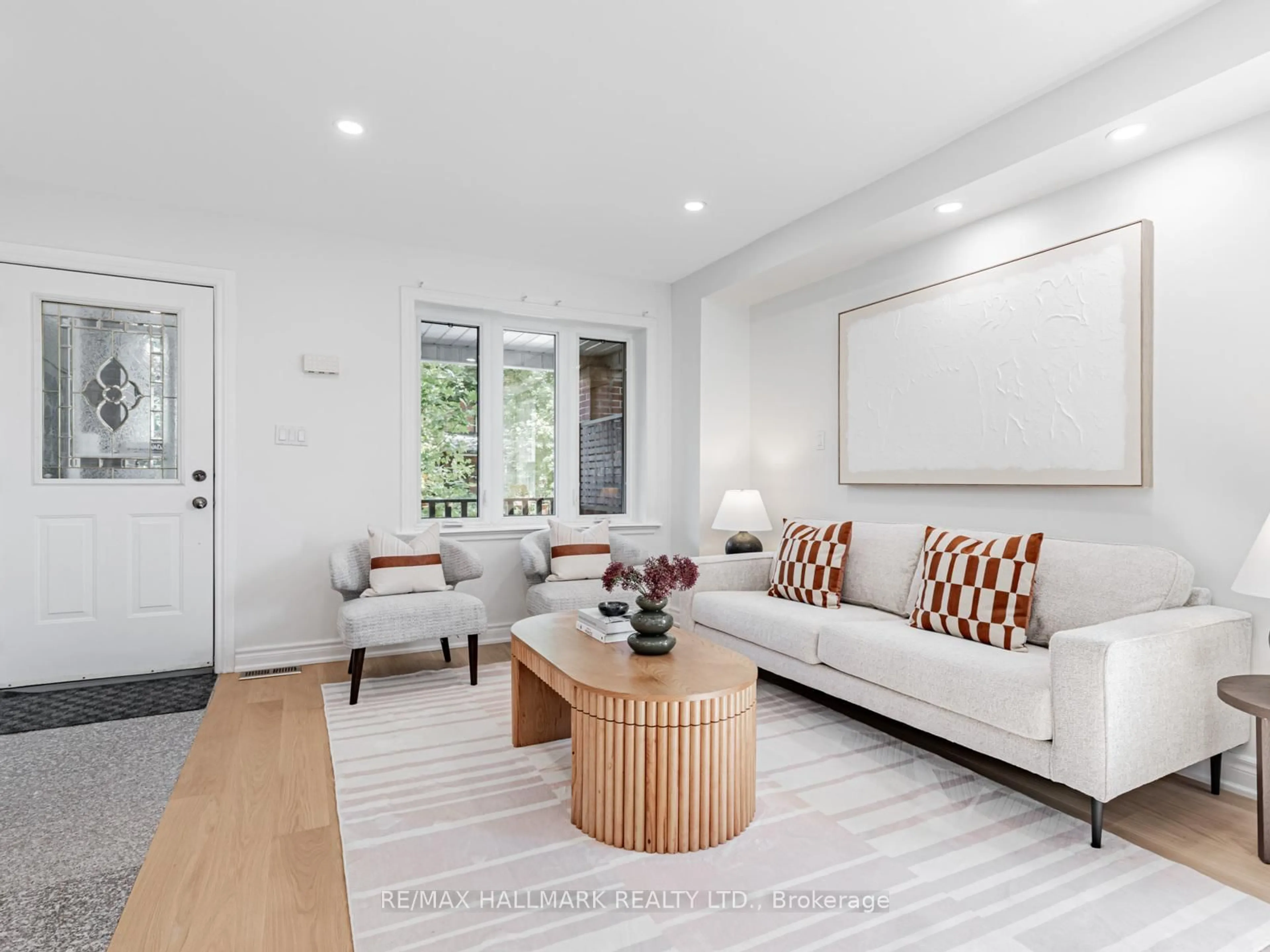 Living room with furniture, wood/laminate floor for 8 Redwood Ave, Toronto Ontario M4L 2S6