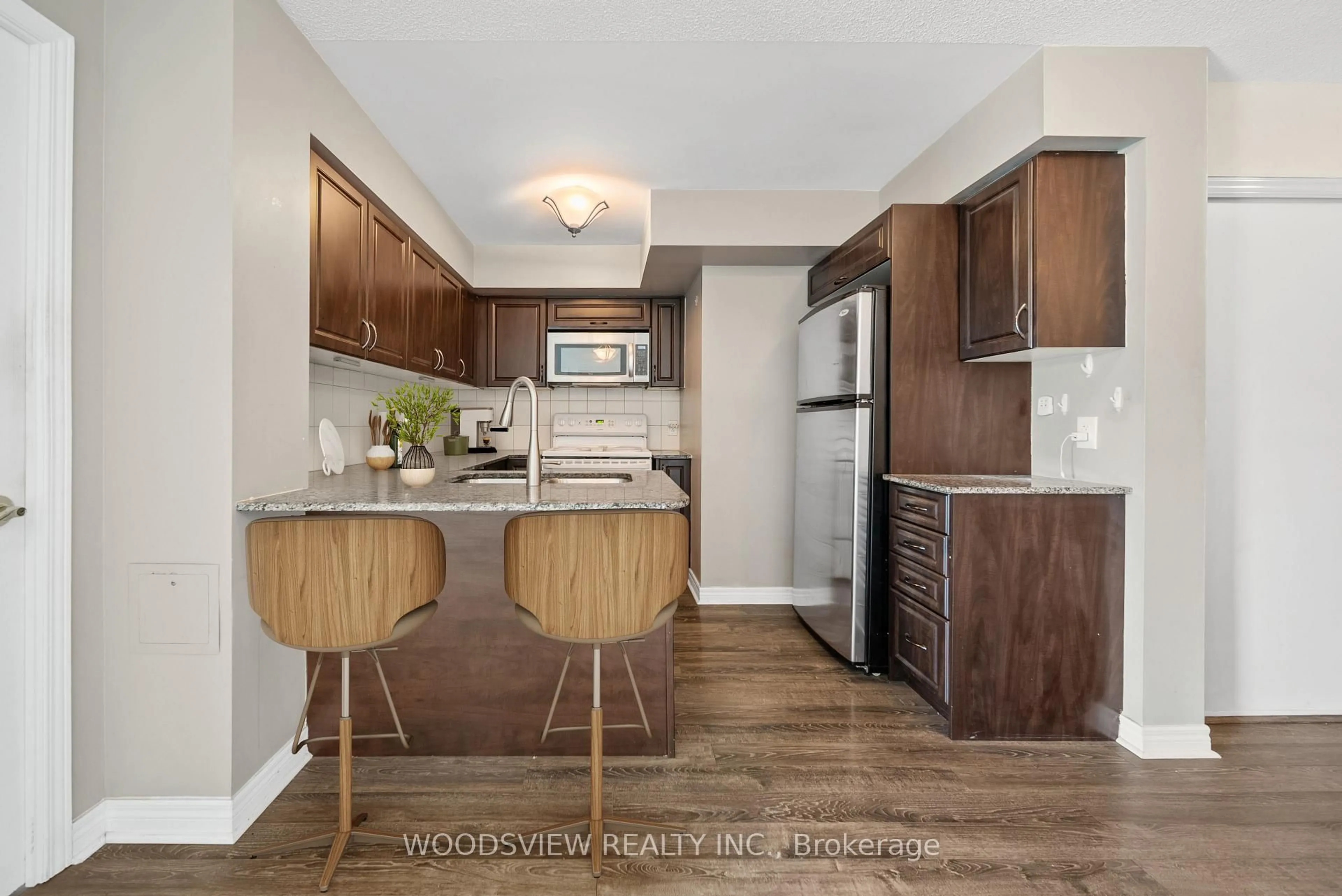 Open concept kitchen, wood/laminate floor for 60 Fairfax Cres #233, Toronto Ontario M1L 1Z8