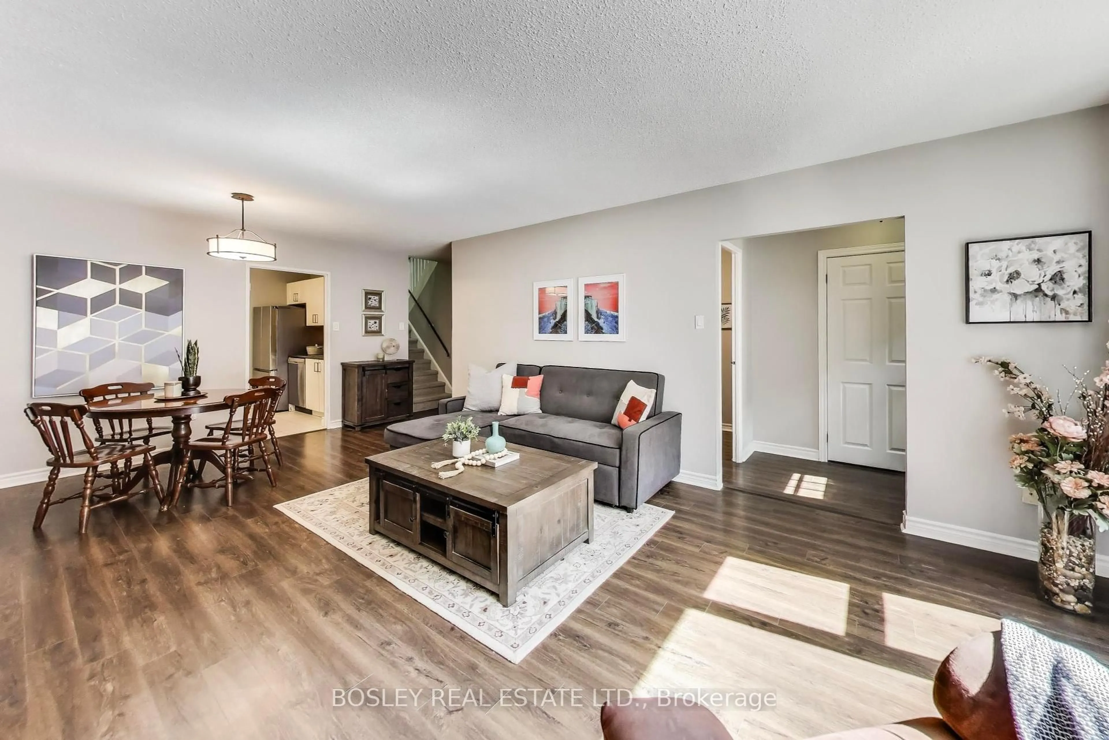 Living room with furniture, wood/laminate floor for 91 Muir Dr #21, Toronto Ontario M1M 3T7
