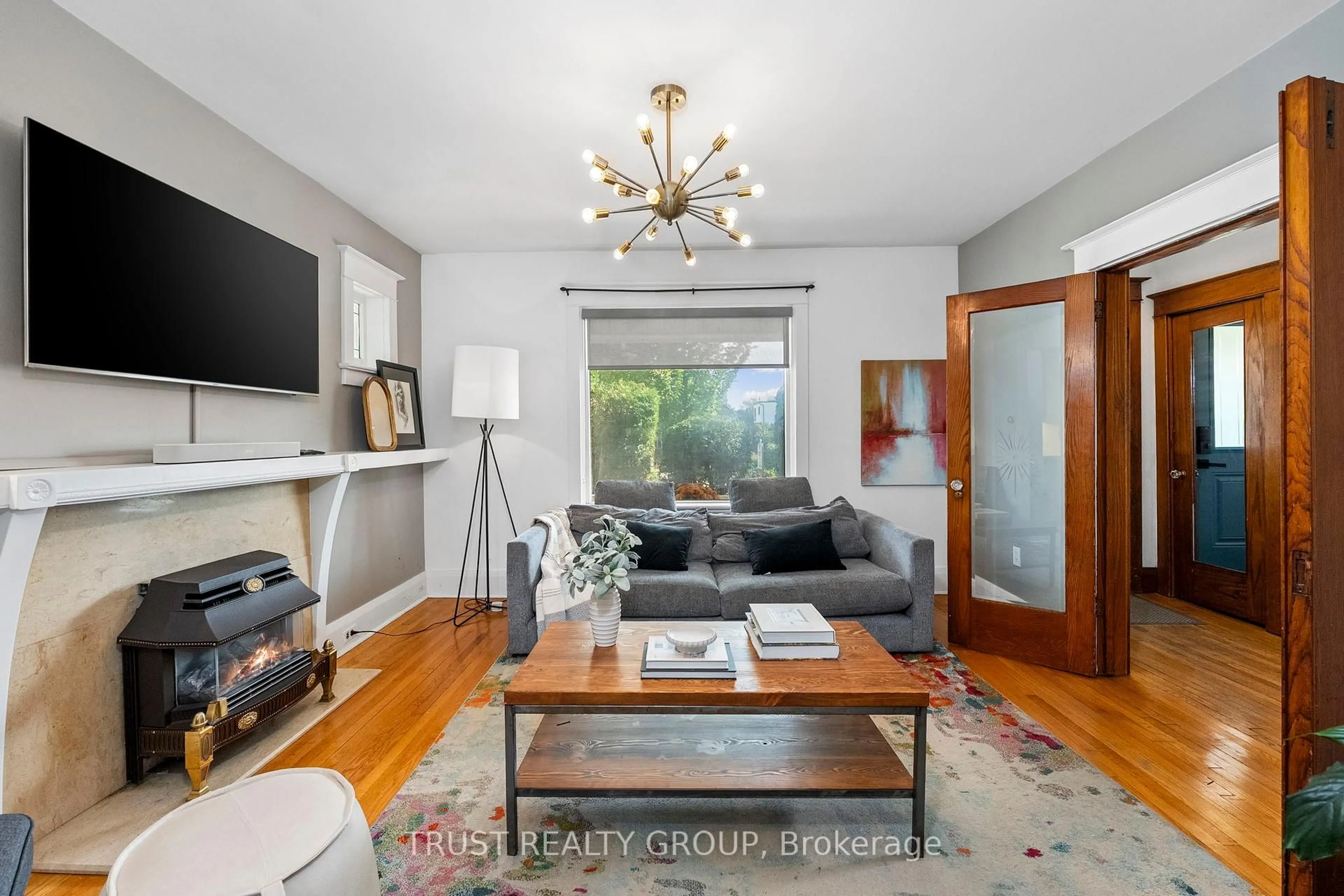 Living room with furniture, wood/laminate floor for 206 Woodmount Ave, Toronto Ontario M4C 3Z6