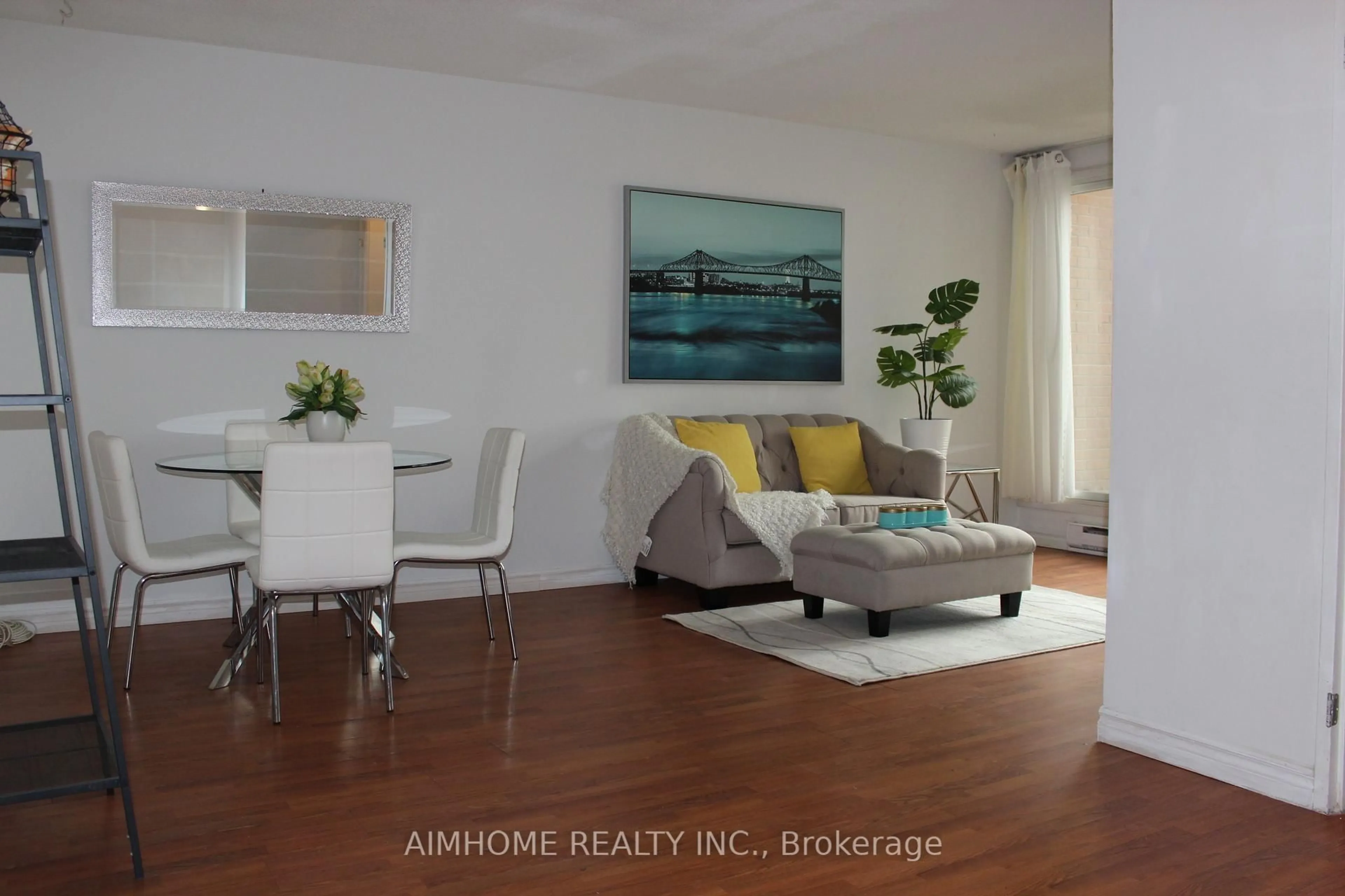 Living room with furniture, wood/laminate floor for 100 Mornelle Crt #1086, Toronto Ontario M1E 4X2