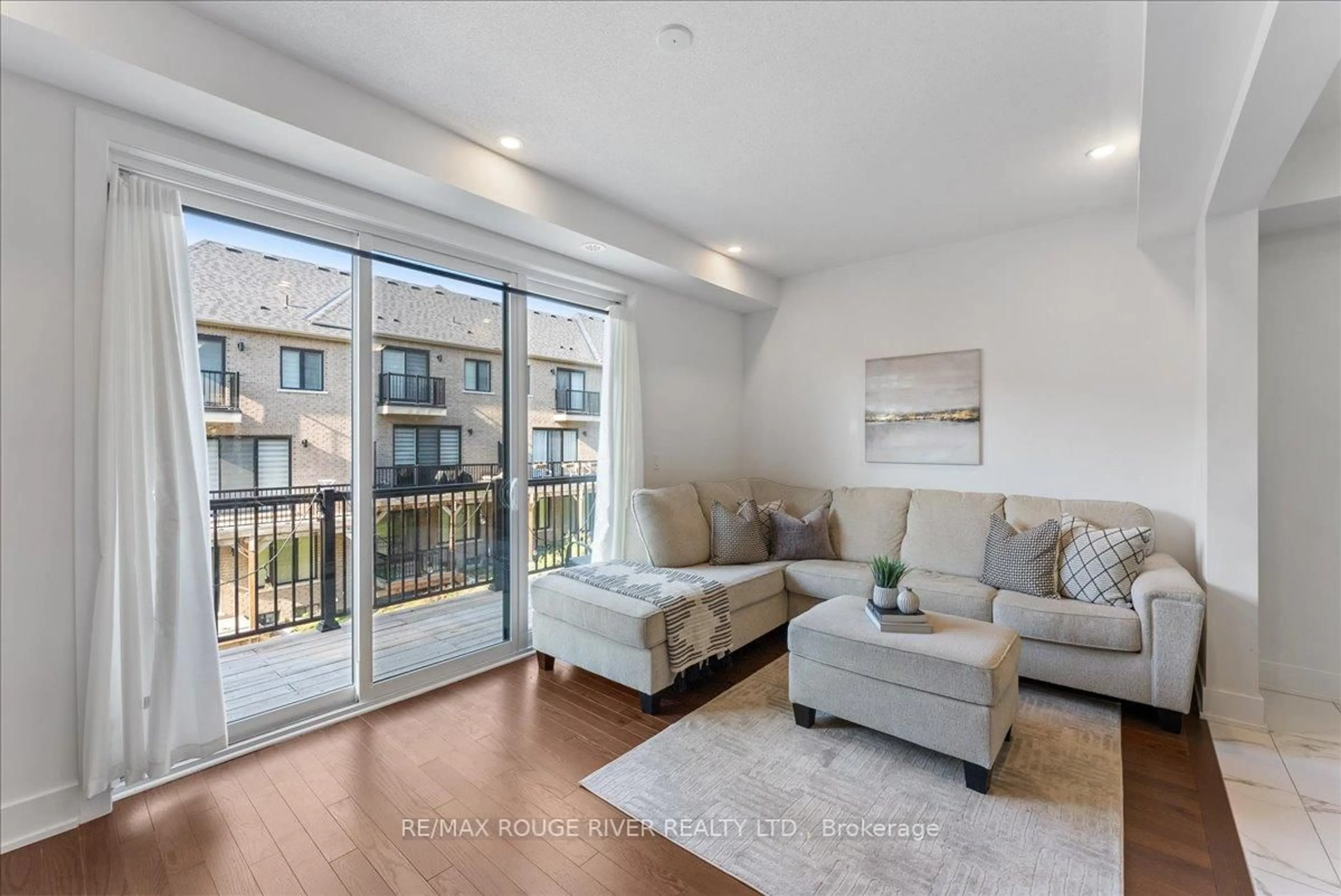 Living room with furniture, wood/laminate floor for 42 Elkington Cres, Whitby Ontario L1P 0L7
