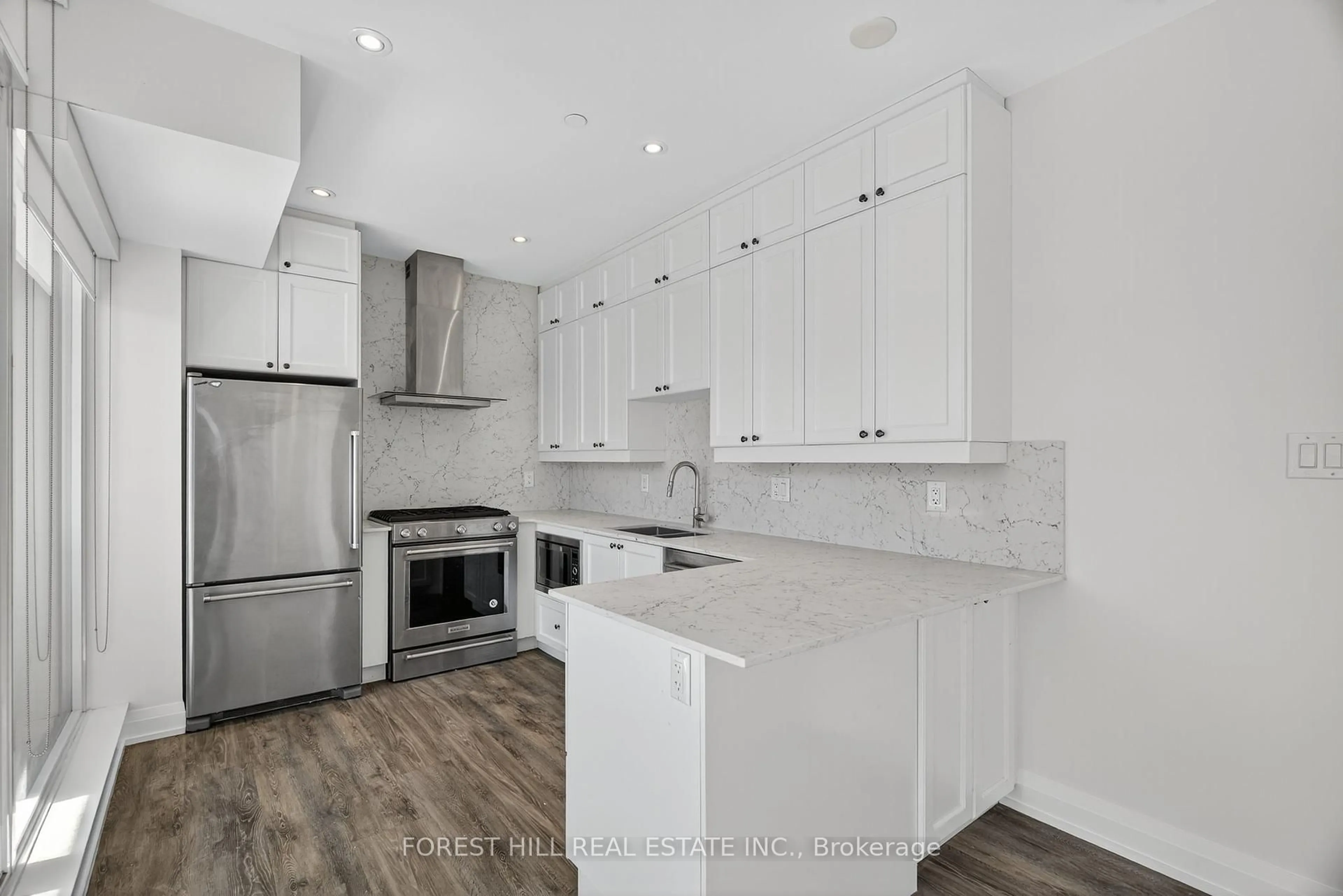 Open concept kitchen, wood/laminate floor for 200 Woodbine Ave #402, Toronto Ontario M4L 3P2