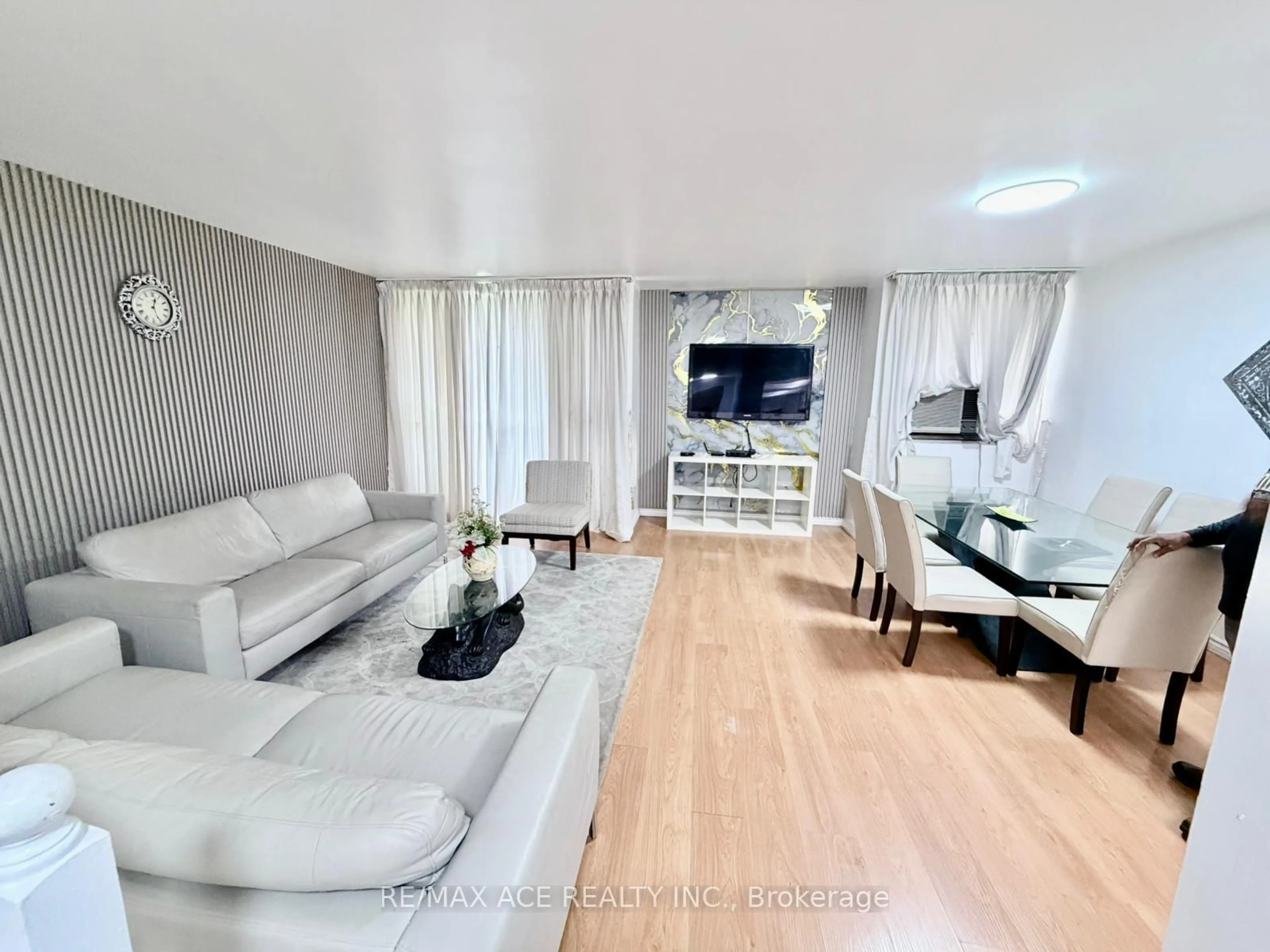 Living room with furniture, wood/laminate floor for 10 Crescent Town Rd #303, Toronto Ontario M4C 5L3