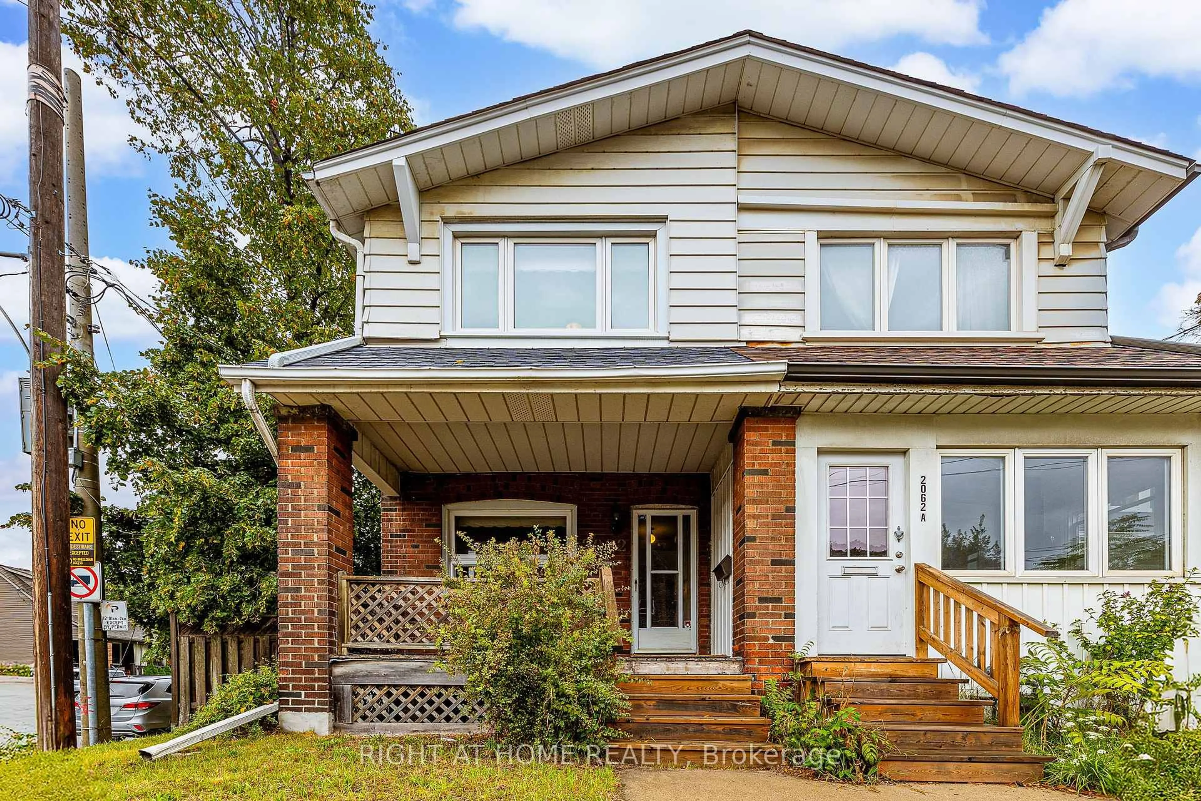 Home with vinyl exterior material, street for 2062 Gerrard St, Toronto Ontario M4E 2B5
