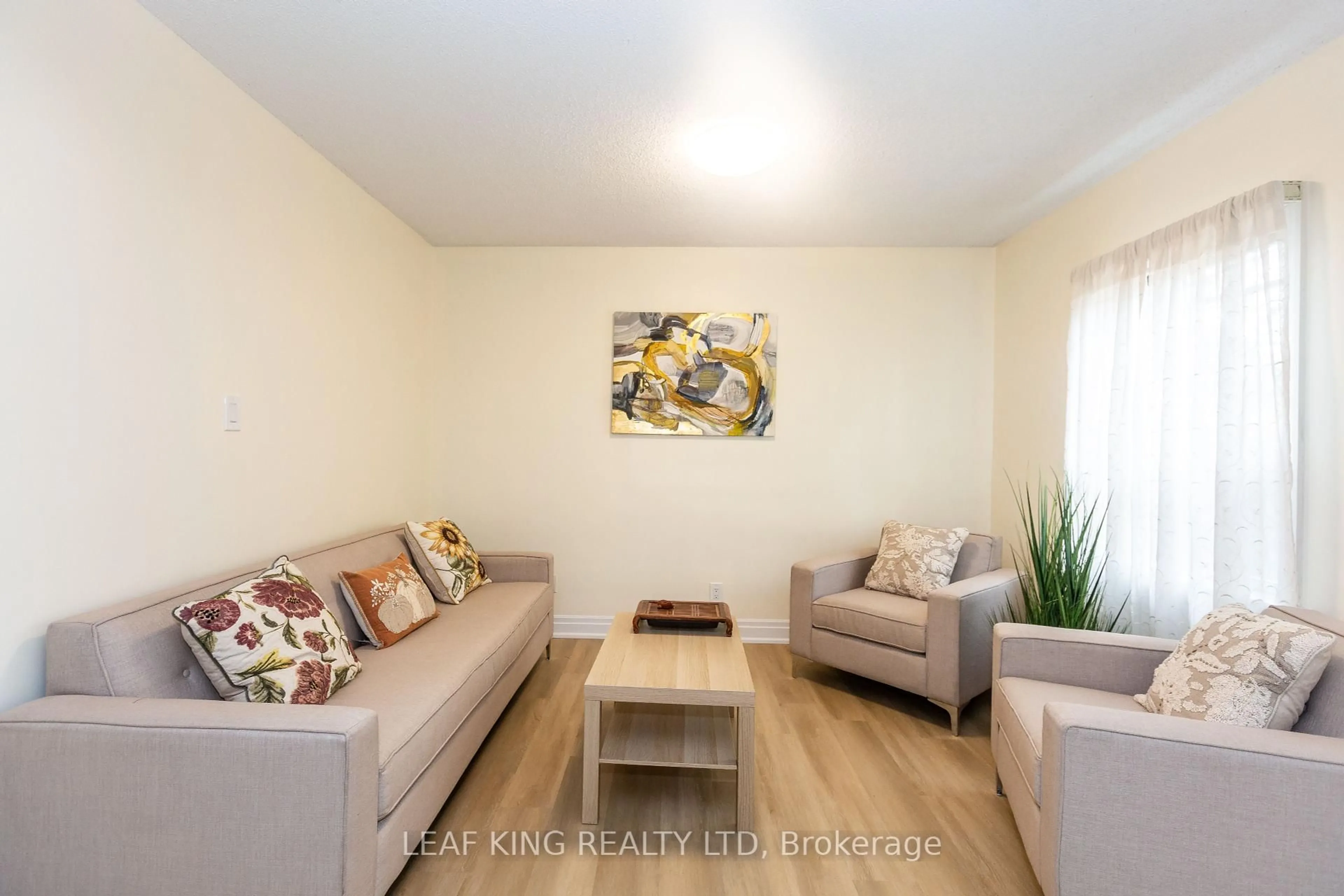 Living room with furniture, wood/laminate floor for 8 Southmead Rd, Toronto Ontario M1L 2H8