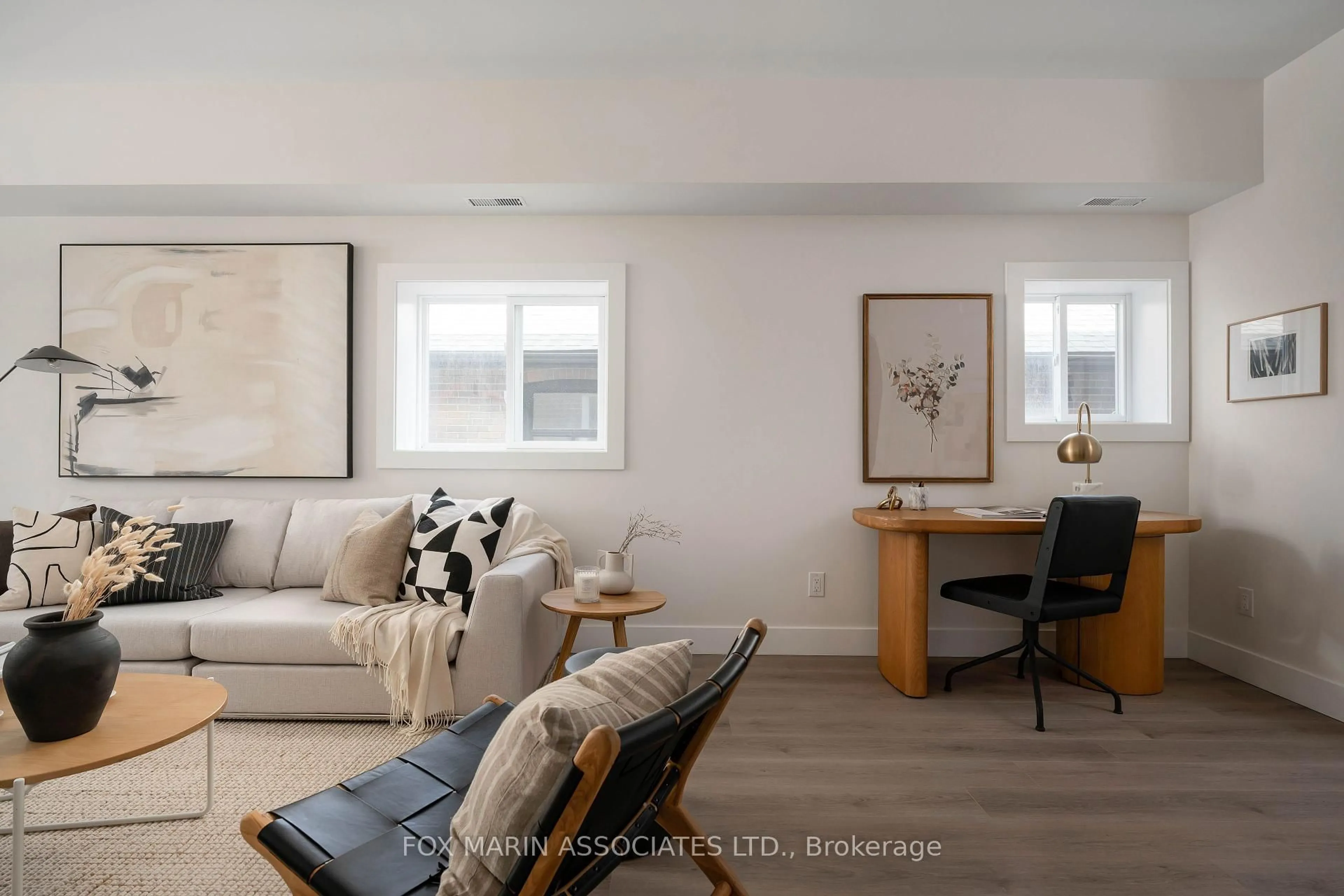 Living room with furniture, wood/laminate floor for 283 Cedarvale Ave, Toronto Ontario M4C 4K3