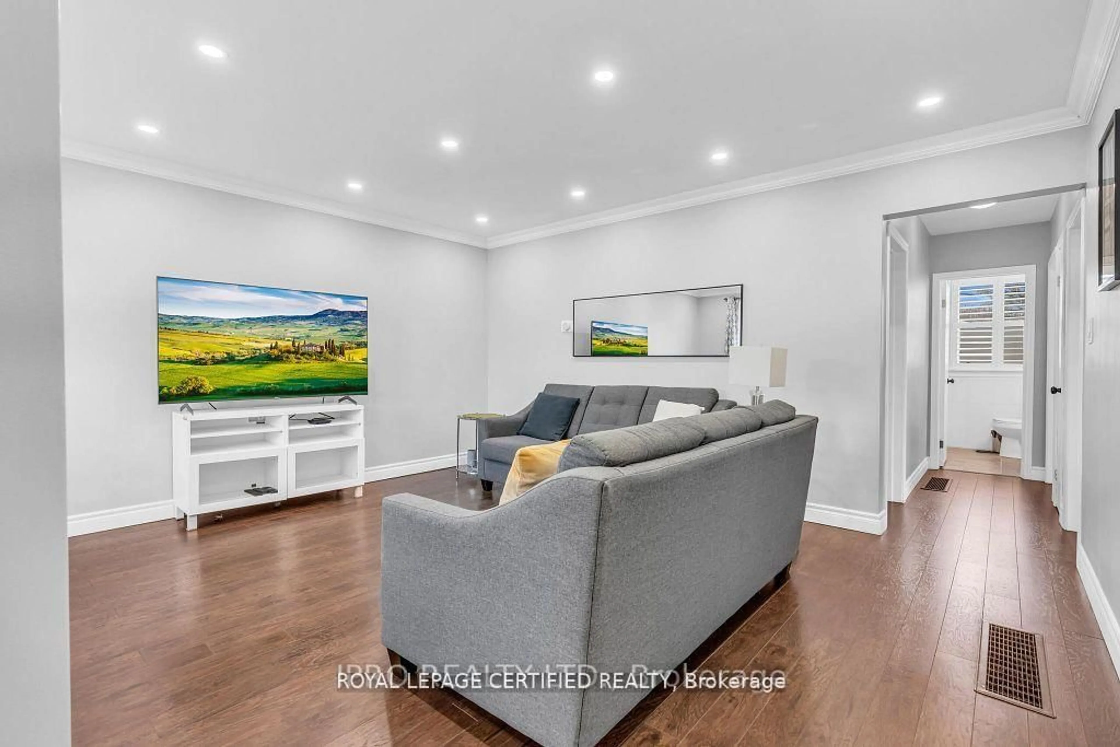 Living room with furniture, wood/laminate floor for 52 Tulloch Dr, Ajax Ontario L1S 2S5