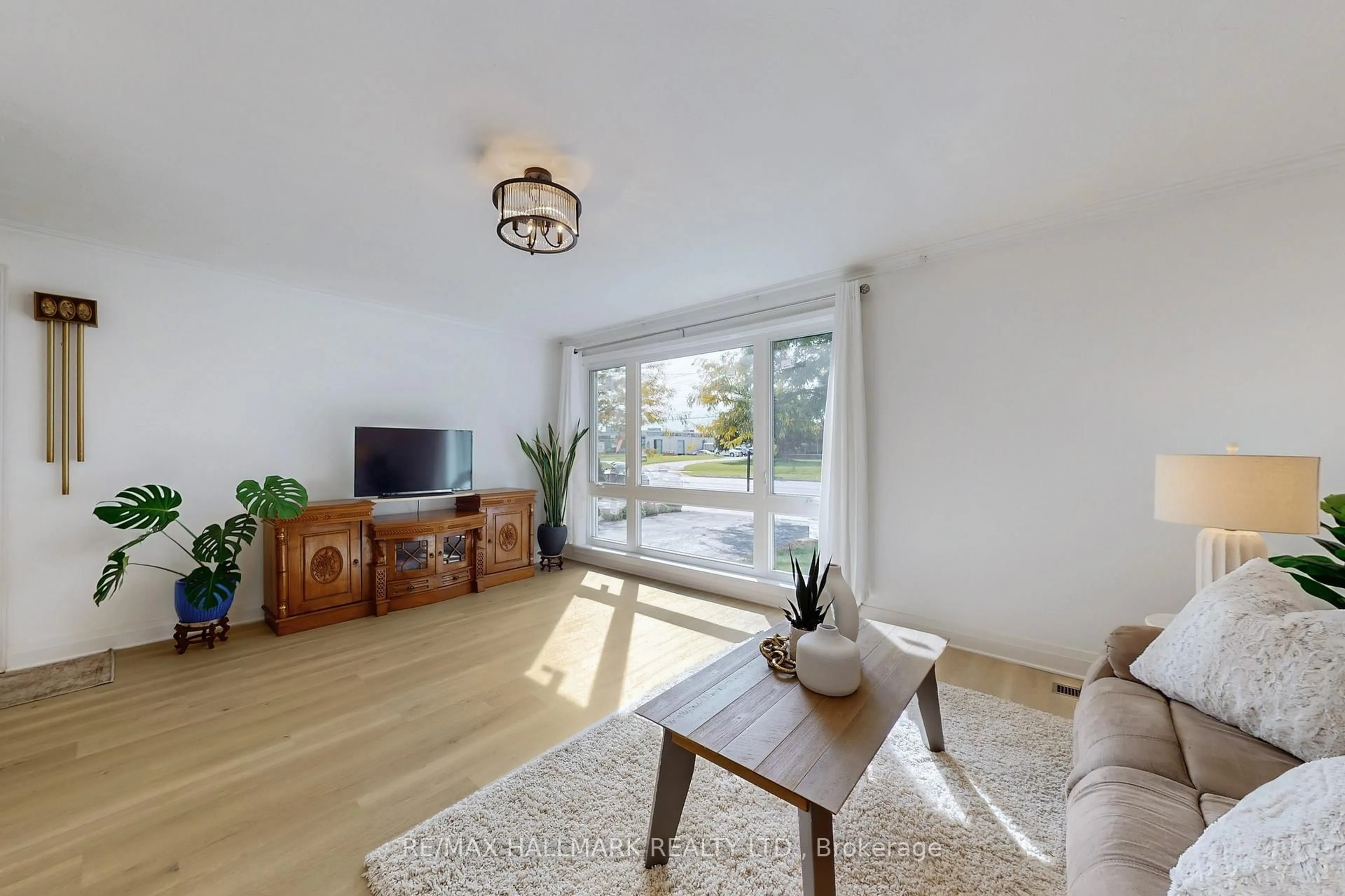Living room with furniture, wood/laminate floor for 1393 Birchmount Rd, Toronto Ontario M1P 2E2