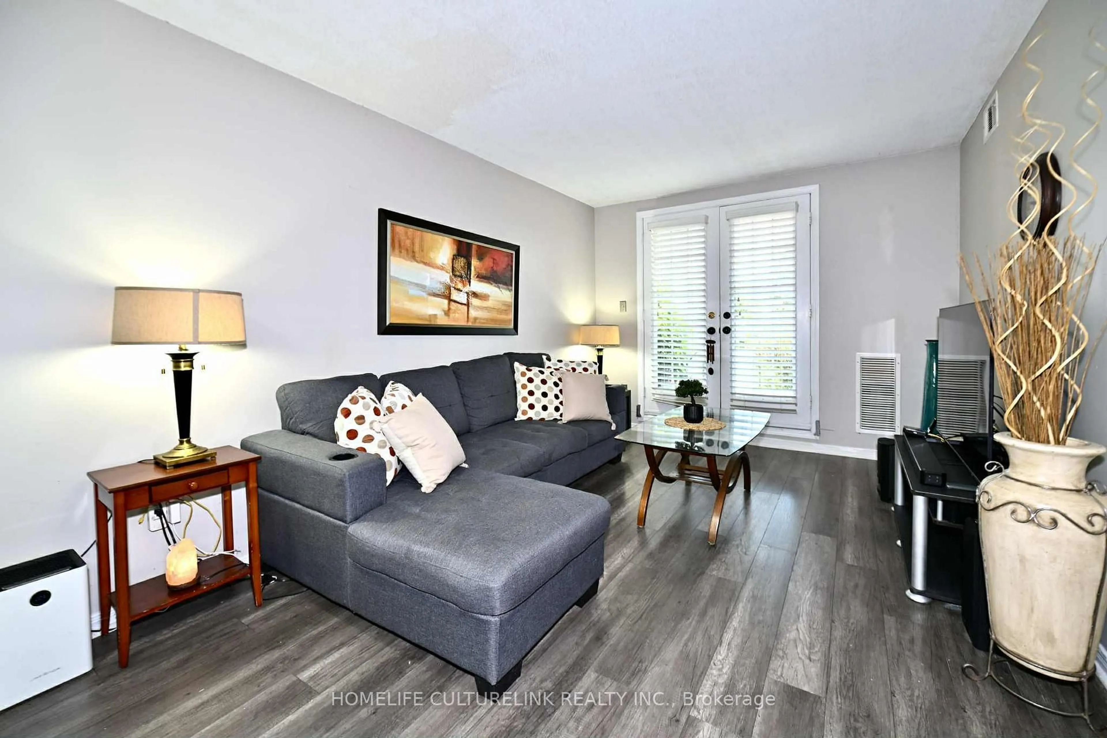 Living room with furniture, wood/laminate floor for 84 Petra Way #1, Whitby Ontario L1R 0A3