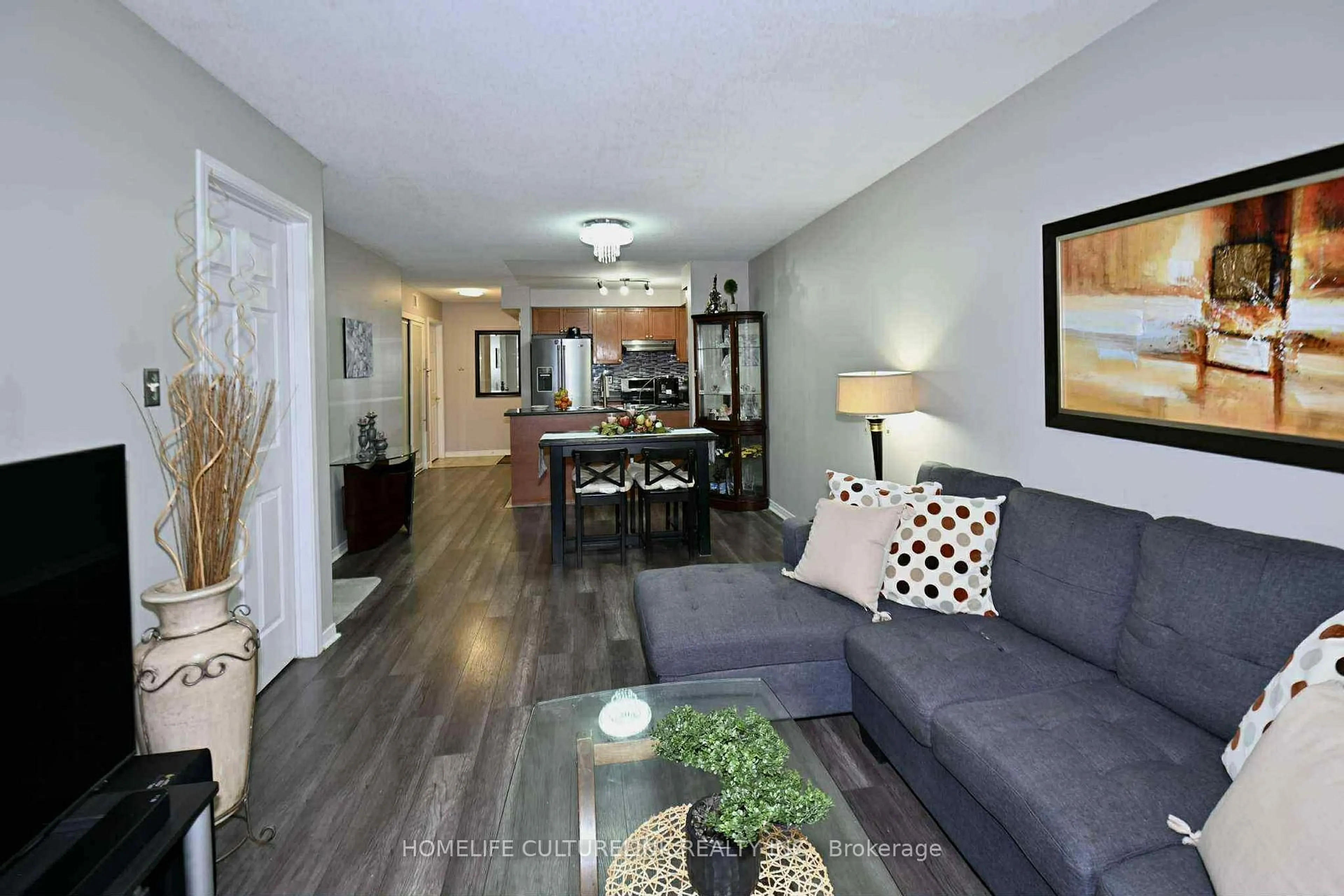 Living room with furniture, wood/laminate floor for 84 Petra Way #1, Whitby Ontario L1R 0A3