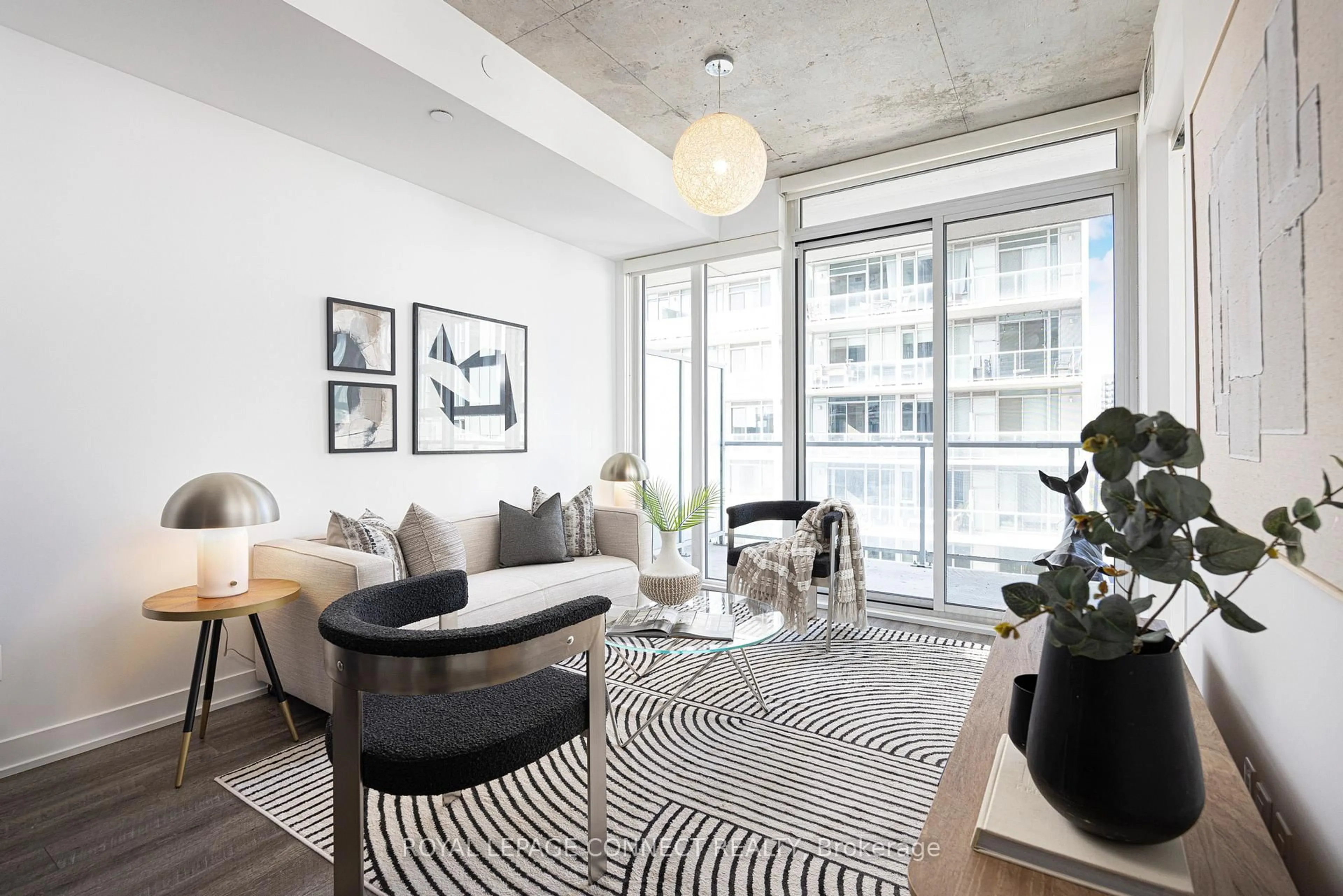 Living room with furniture, cement floor for 25 Baseball Pl #710, Toronto Ontario M4M 0E7